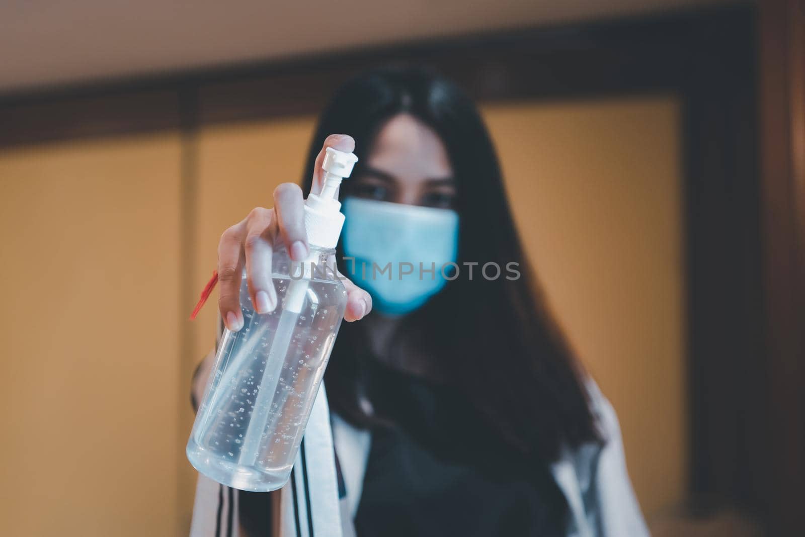 Asian woman wearing mask and alcohol antibacterial hand gel respiratory protection mask against epidemic flu covid19 or corona virus with fear emotion in concept illness, outbreak, healthcare in life