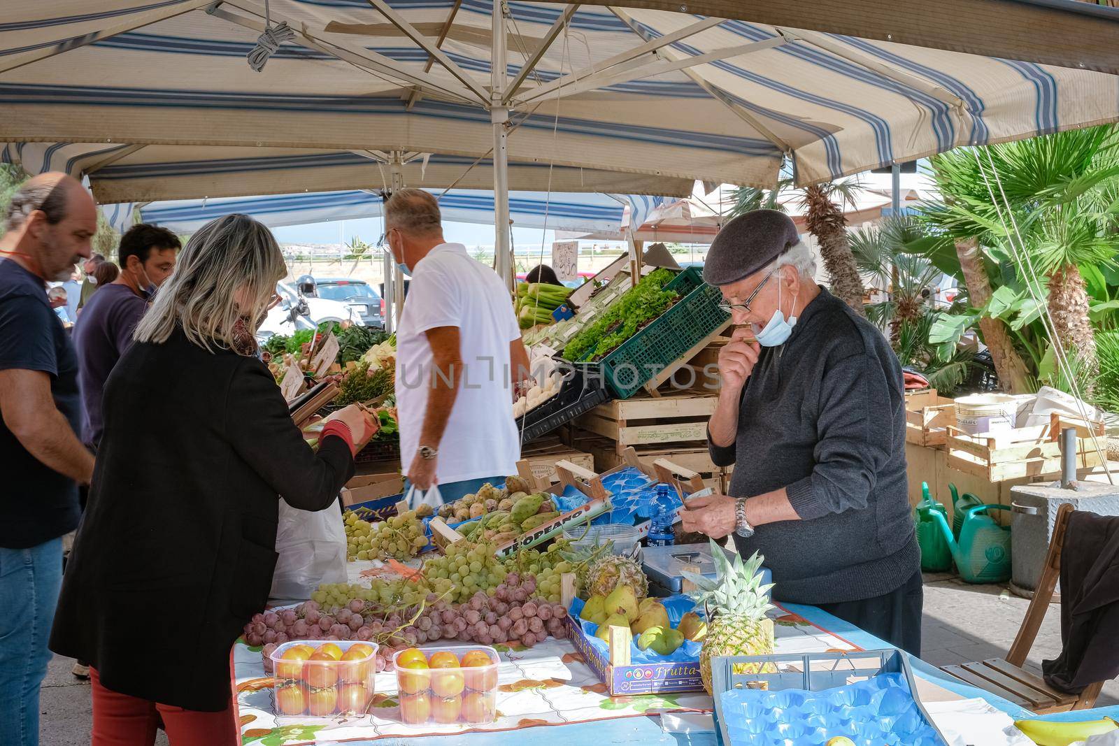 Ortigia in Syracuse in the Morning. Travel Photography from Syracuse, Italy on the island of Sicily. Cathedral Plaza and market with people whear face protection during the 2020 pandemic by fokkebok