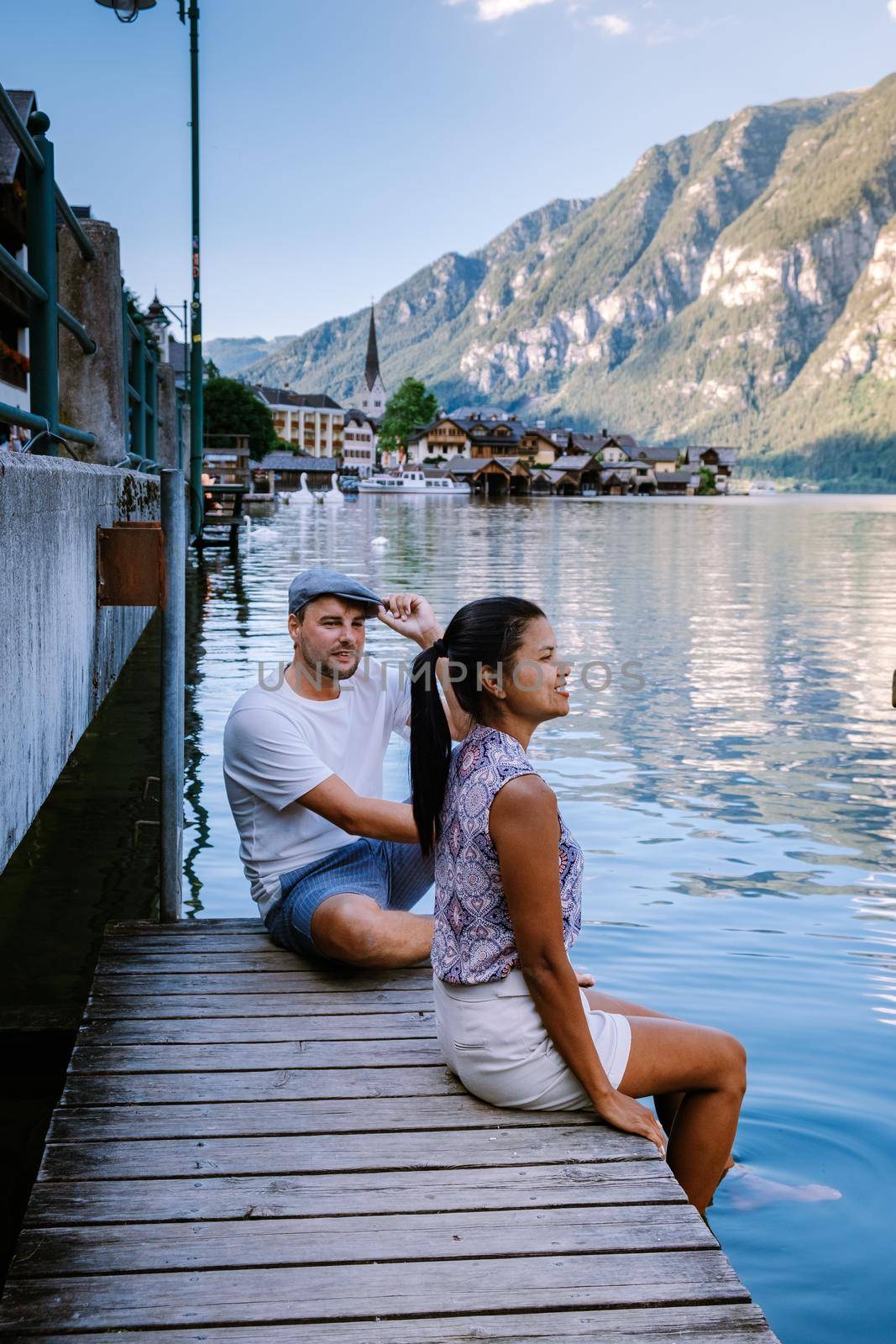 couple visit during summer vacation Hallstatt village on Hallstatter lake in Austrian Alps Austria Europe