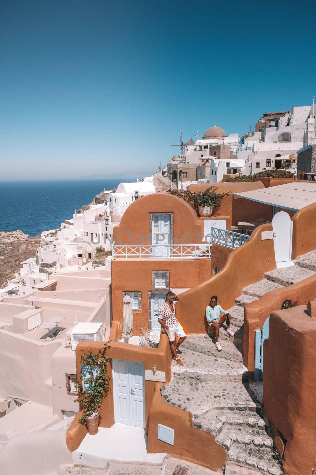 Santorini Island Greece, couple men and woman on vacation at the Greek Island of Santorini visit the white village of Oia Santorini by fokkebok