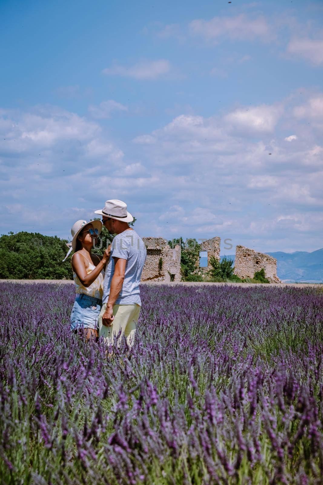 Couple men and woman on vacation at the provence lavender fields, Provence, Lavender field France, Valensole Plateau, colorful field of Lavender Valensole Plateau, Provence, Southern France. Lavender field by fokkebok