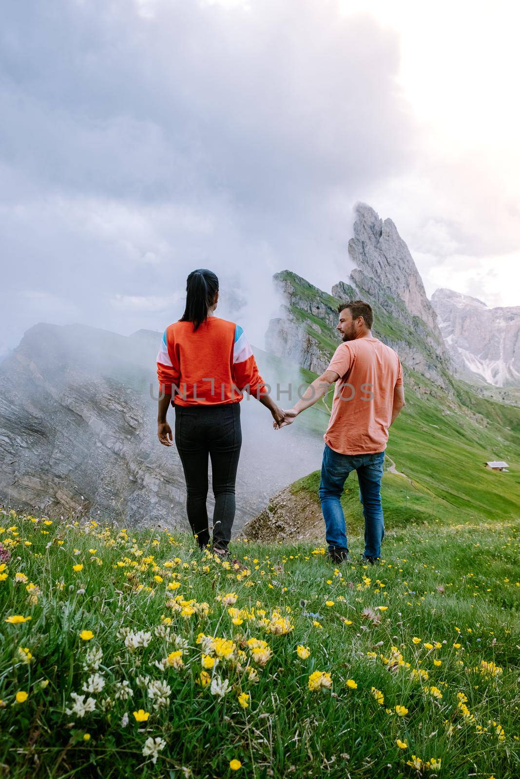 couple on vacation hiking in the Italien Dolomites, Amazing view on Seceda peak. Trentino Alto Adige, Dolomites Alps, South Tyrol, Italy, Europe. Seceda Peak