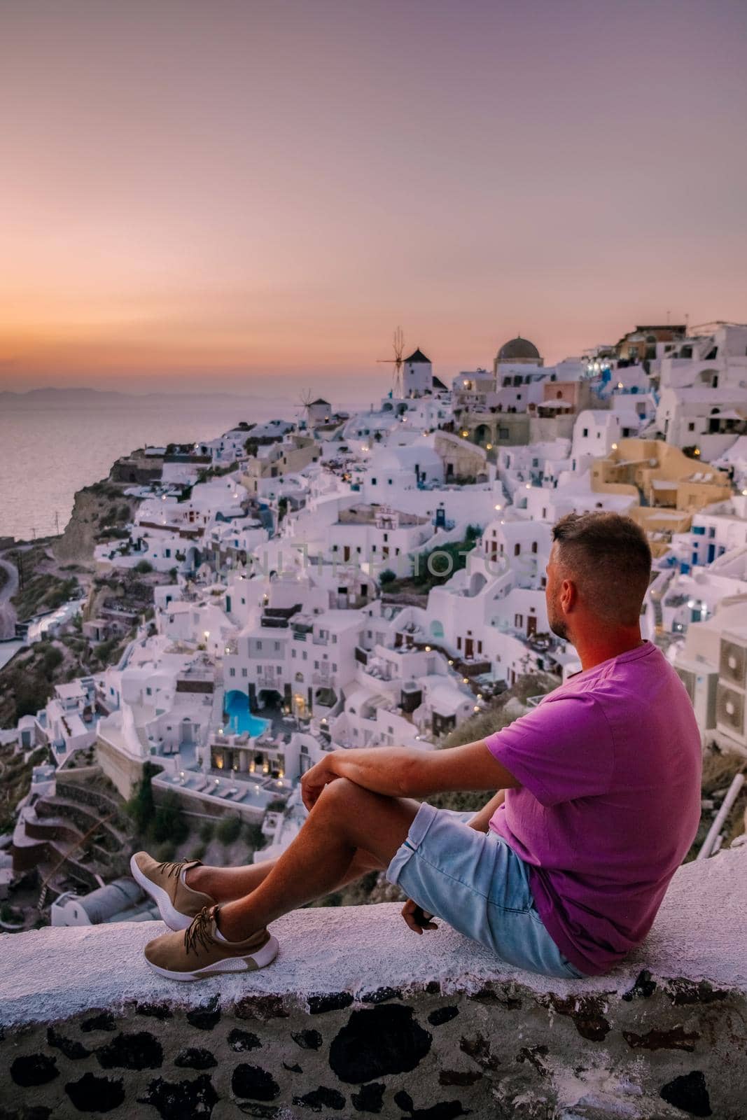 Santorini Greece, guy on vacation in Greece, young men on a luxury holiday at the island of Oia Greece by fokkebok