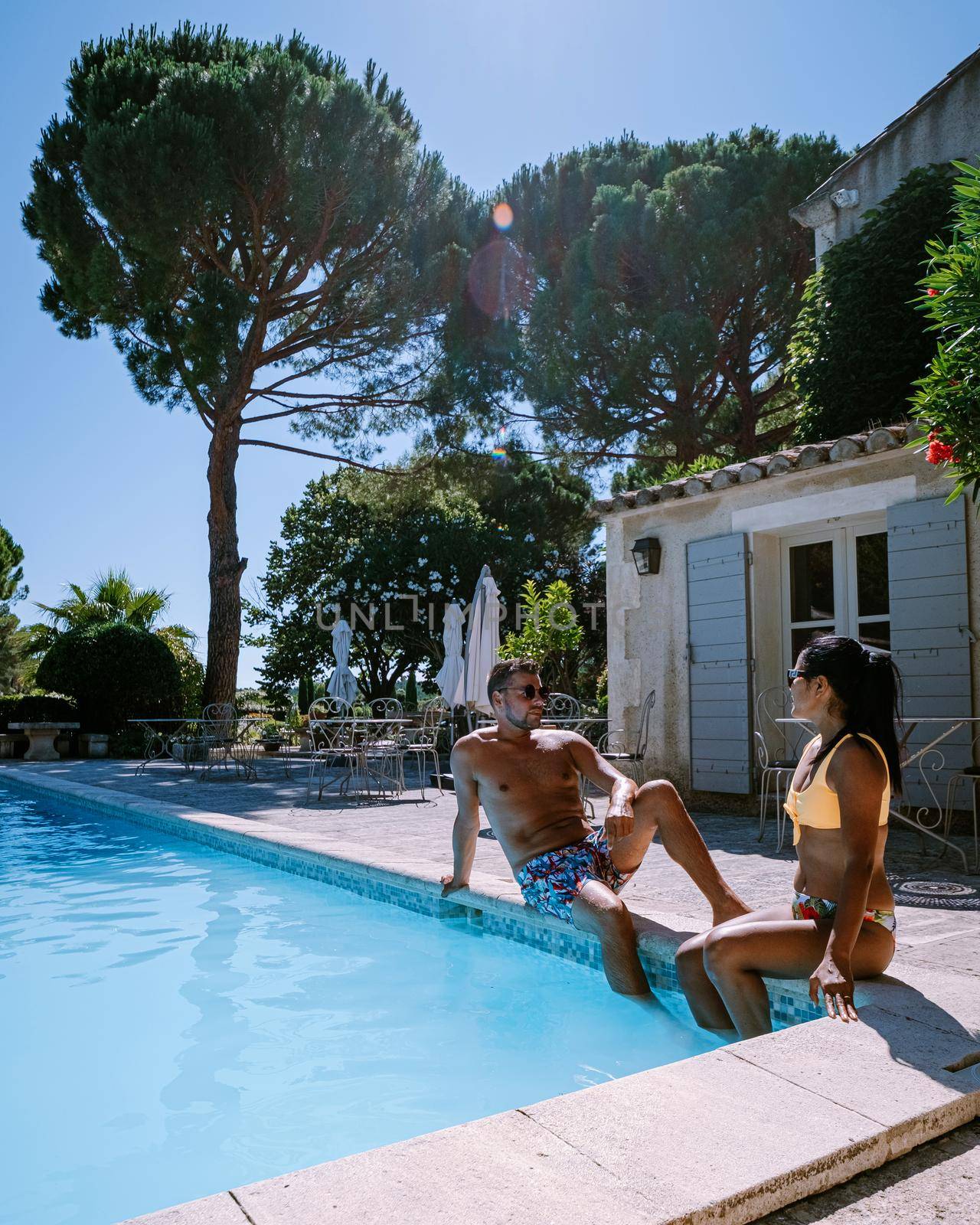 couple relaxing by the pool in the Provence France, men and woman relaxing by pool at luxury resort France
