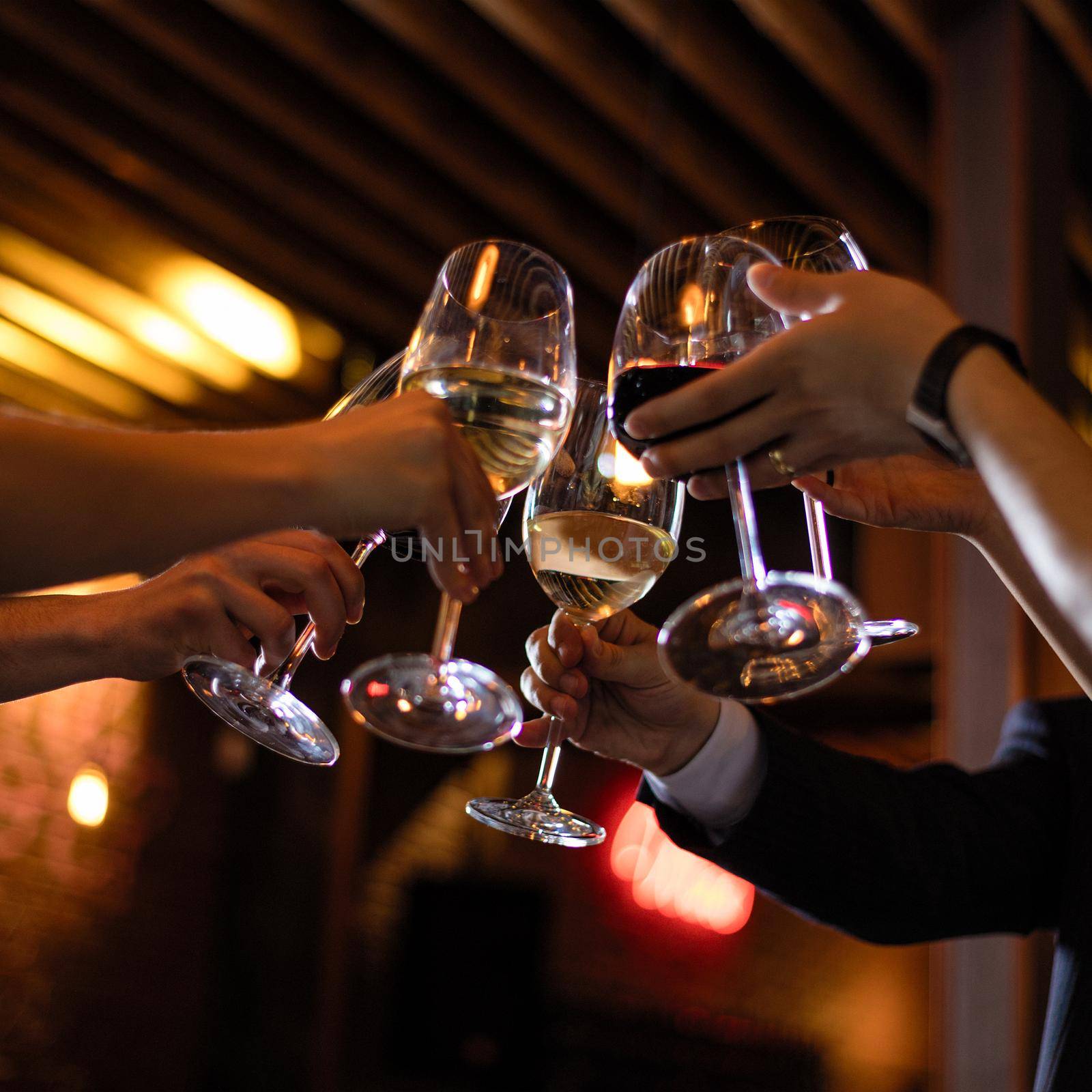 People clinking wine glasses at the event, view from below by ferhad