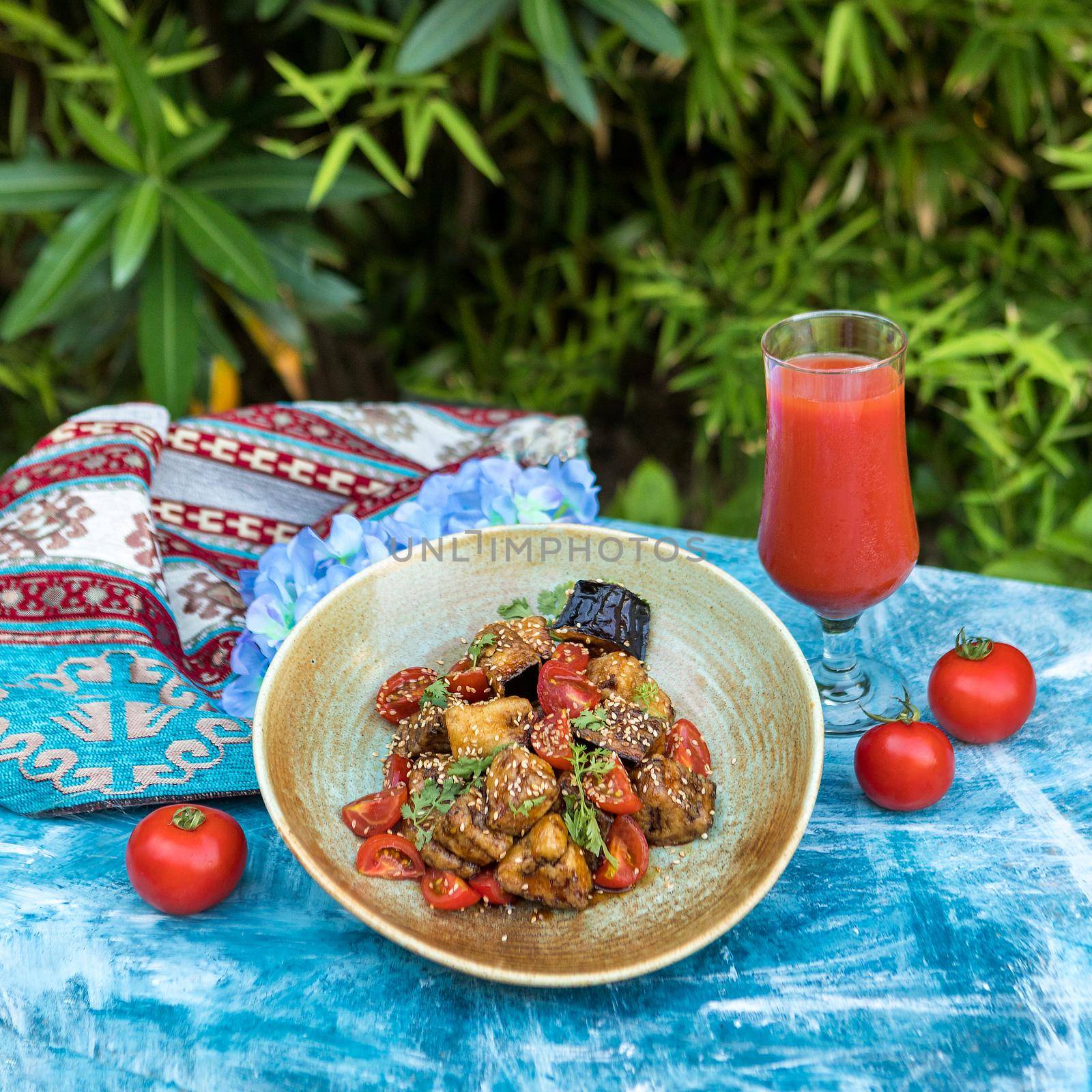 Beautiful eggplant salad with tomato, juice with green background