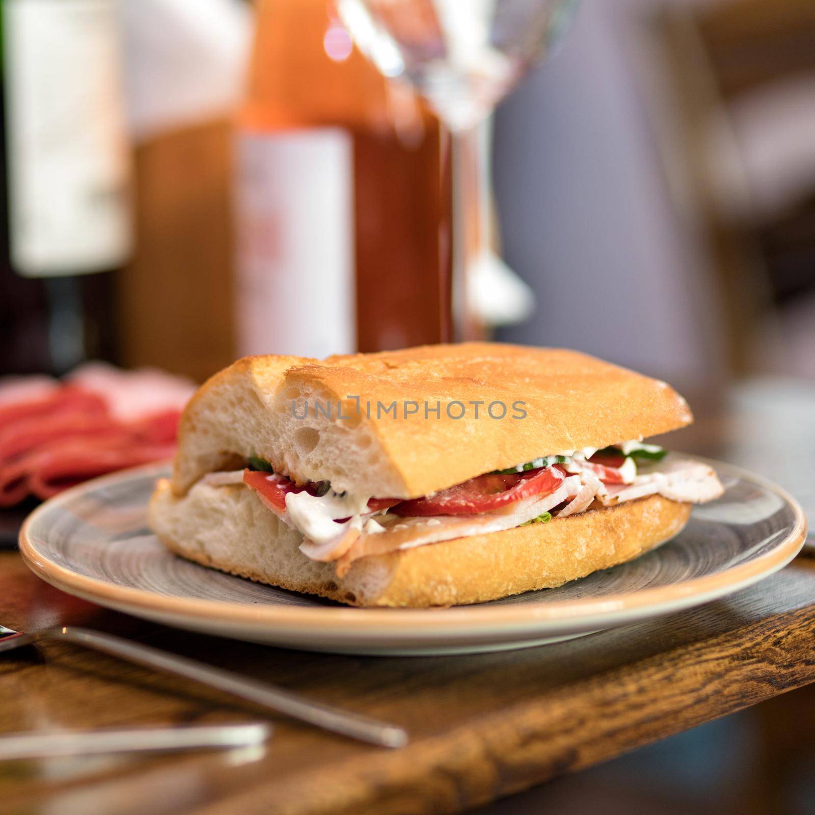 Tasty sandwich with red wine on the table by ferhad