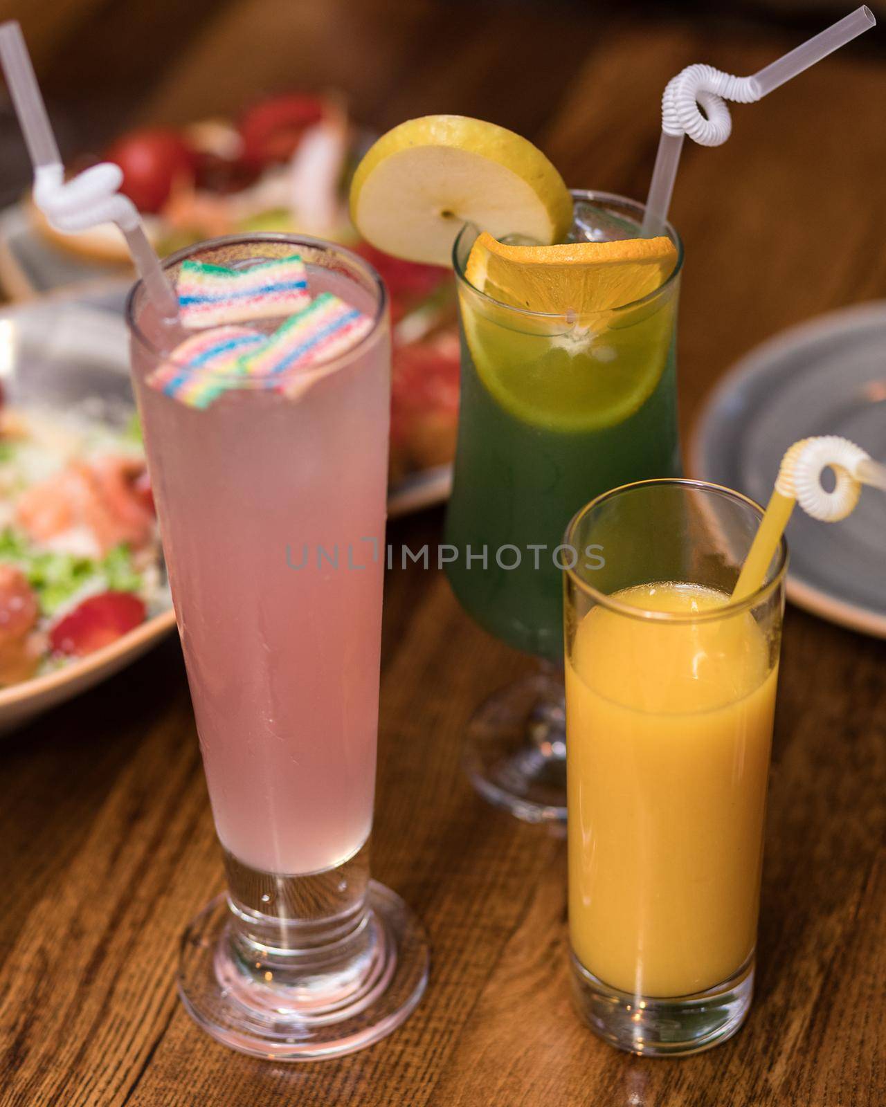 Tasty orange, lemon, marshmallow juice cocktails on the table by ferhad