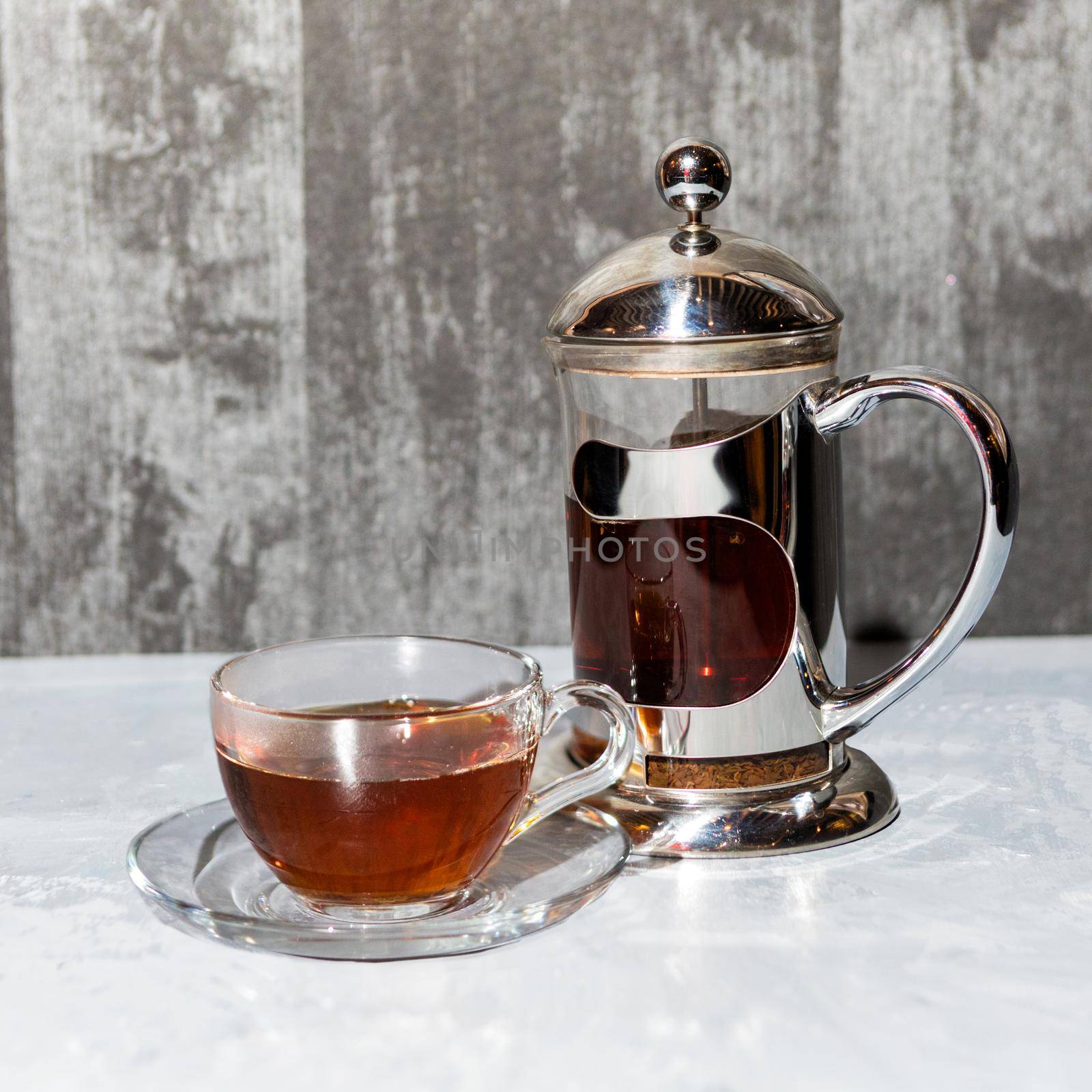 Tea glass and teapot, tea set on a silver background