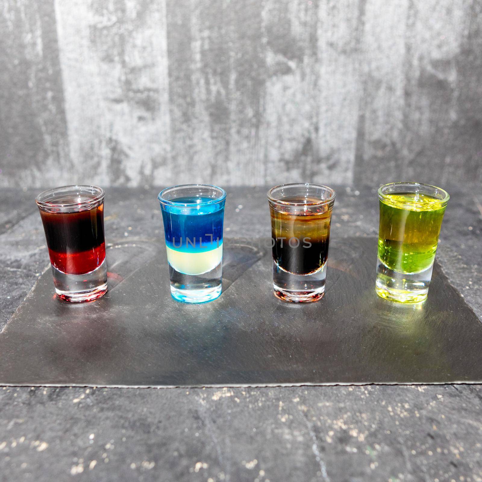 Colorful alcohol vodka cocktails on a gray background by ferhad