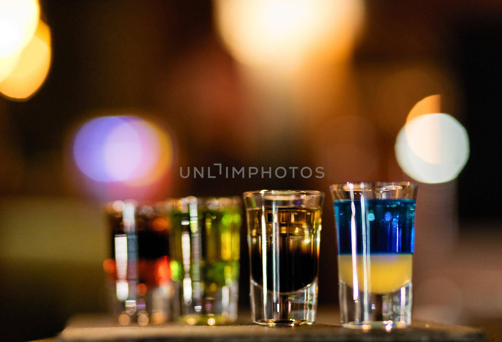 Colorful alcohol vodka cocktails on a bokeh background by ferhad