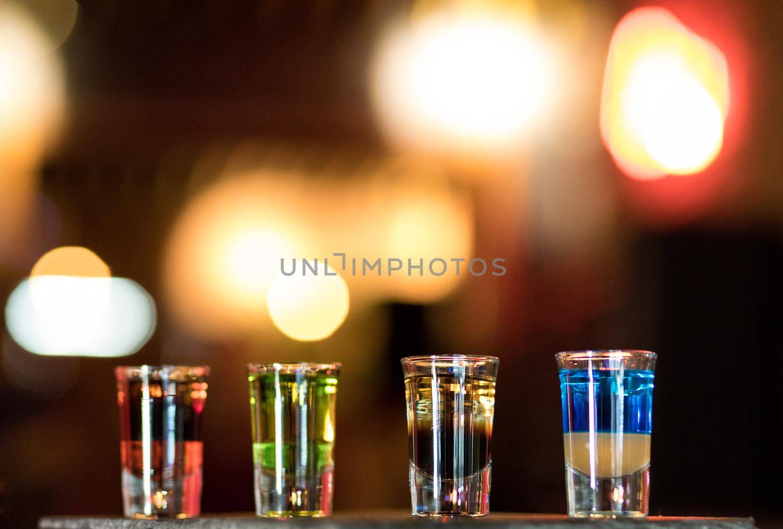 Colorful alcohol vodka cocktails on a bokeh background by ferhad