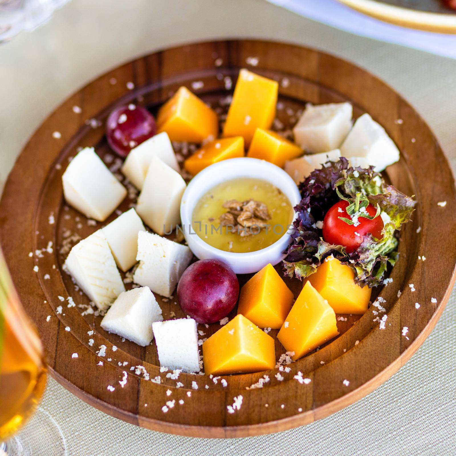 Assorted cheese with sauce on the wooden plate