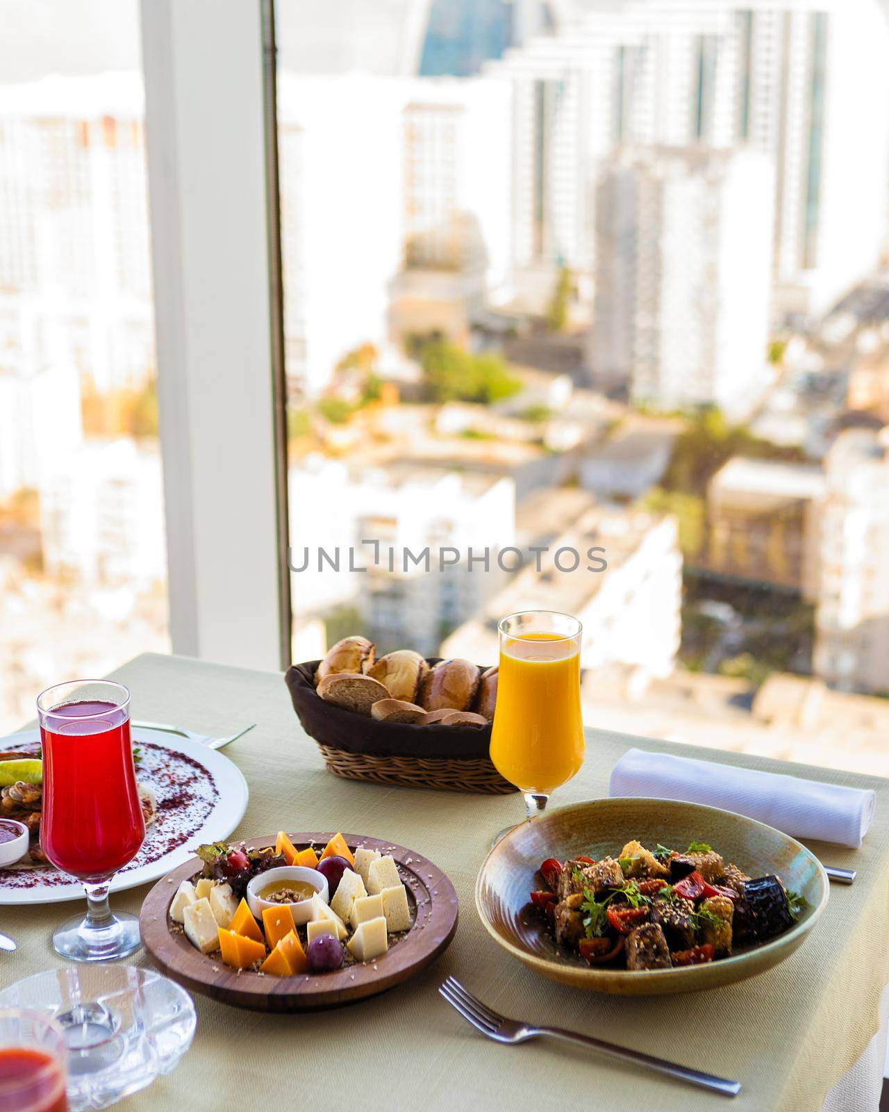 Tasty meals, cheese mix, fruit juice on the restaurant table by ferhad
