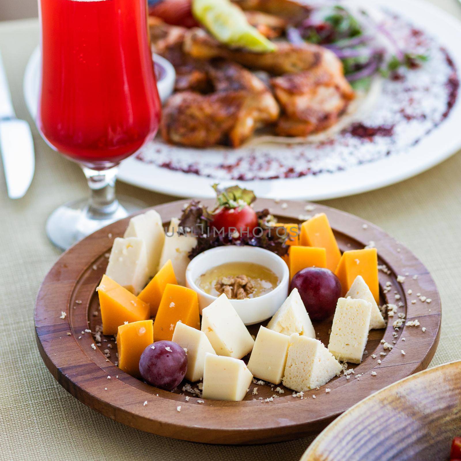 Assorted cheese with sauce on the wooden plate