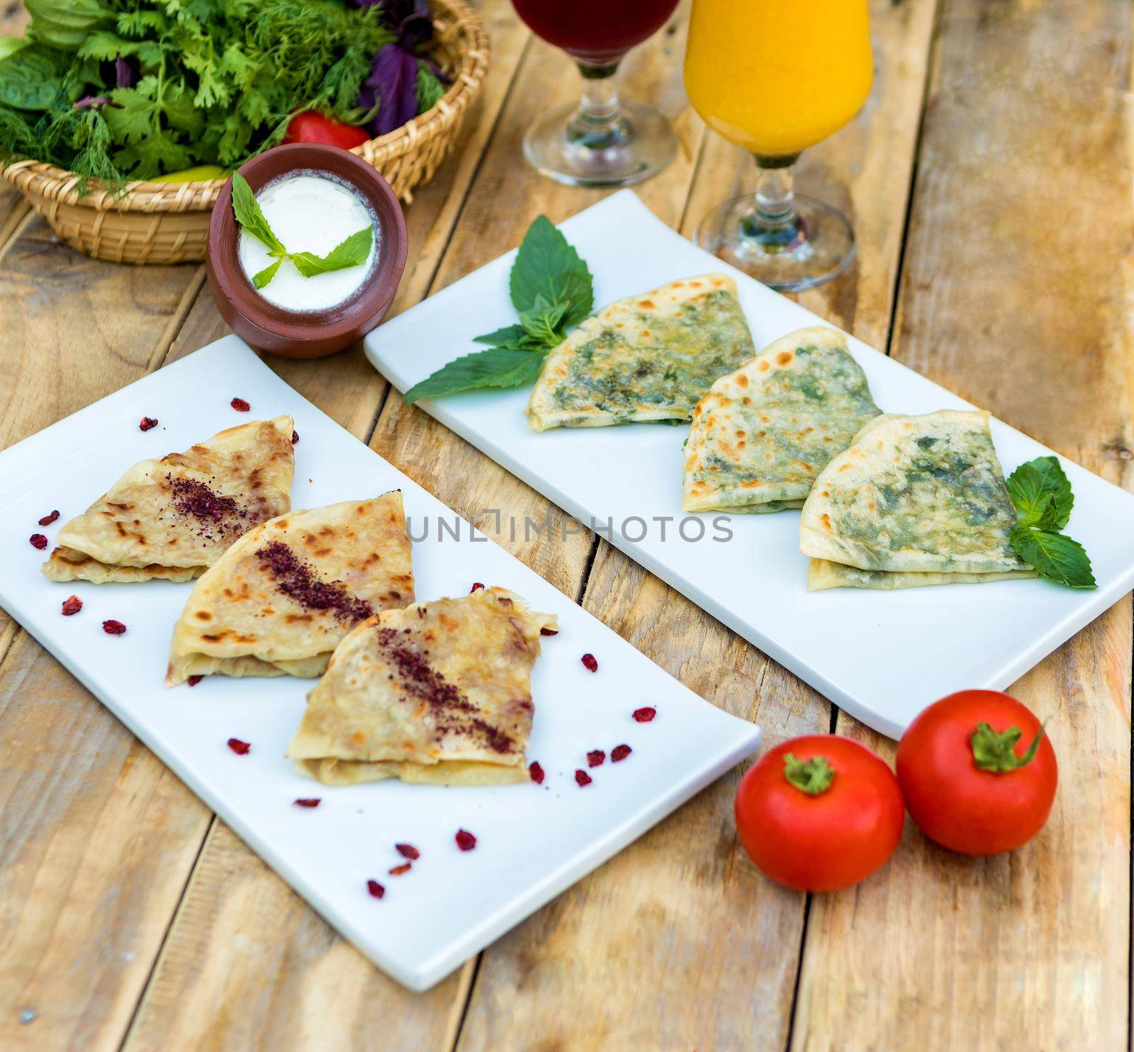 Tasty qutab, Azerbaijani meal with yogurt on the wooden plate by ferhad