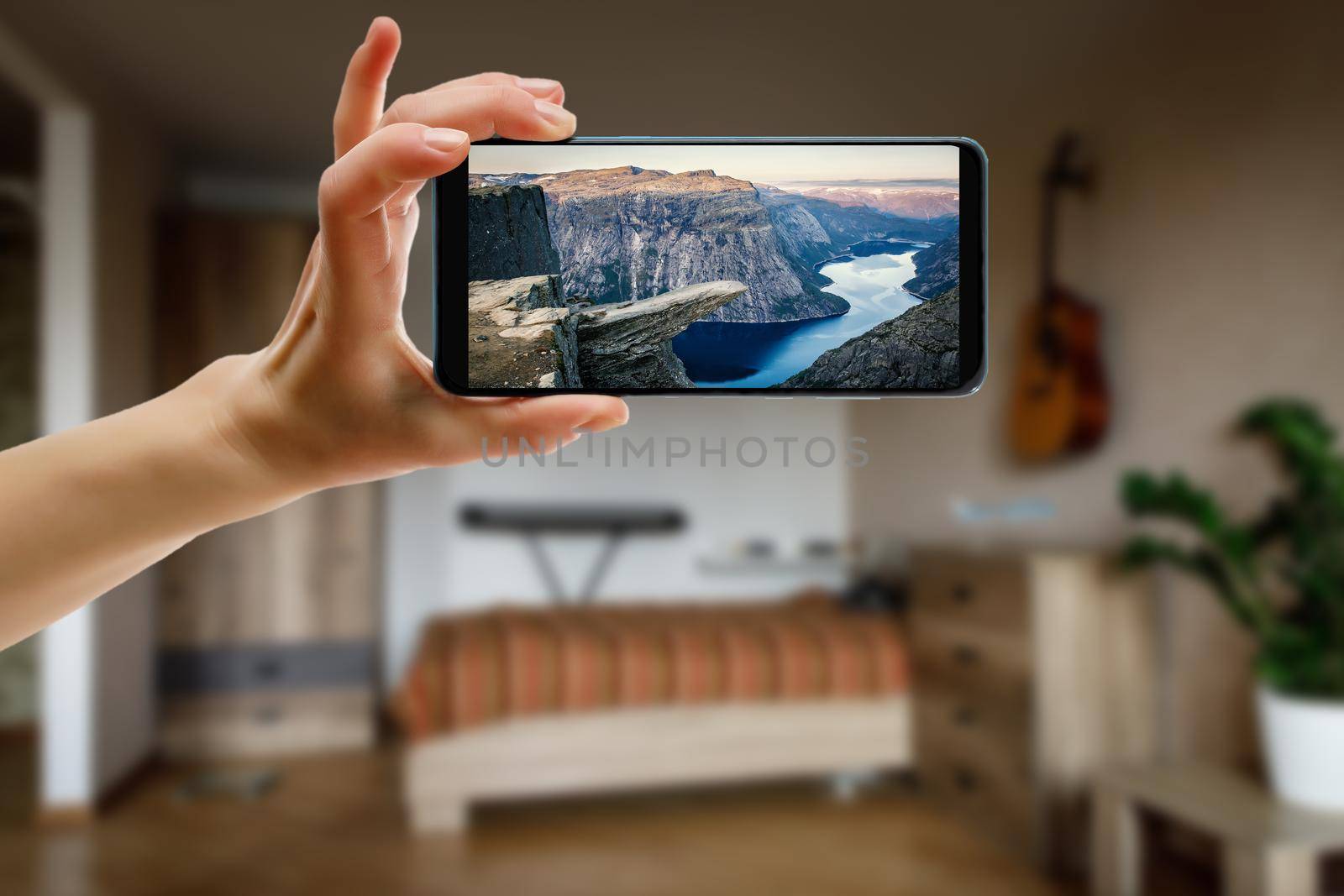 Norway on the screen. View famous tourist spots from home. Online travel concept. by 9parusnikov