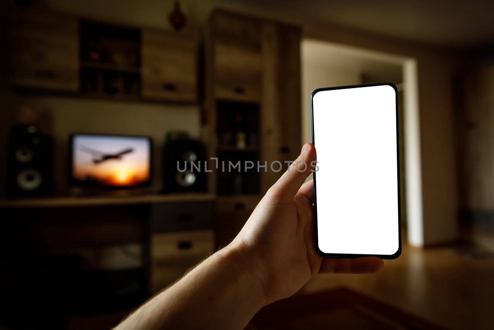 Mockup of using a smartphone in the home interior. Blank white screen for your idea