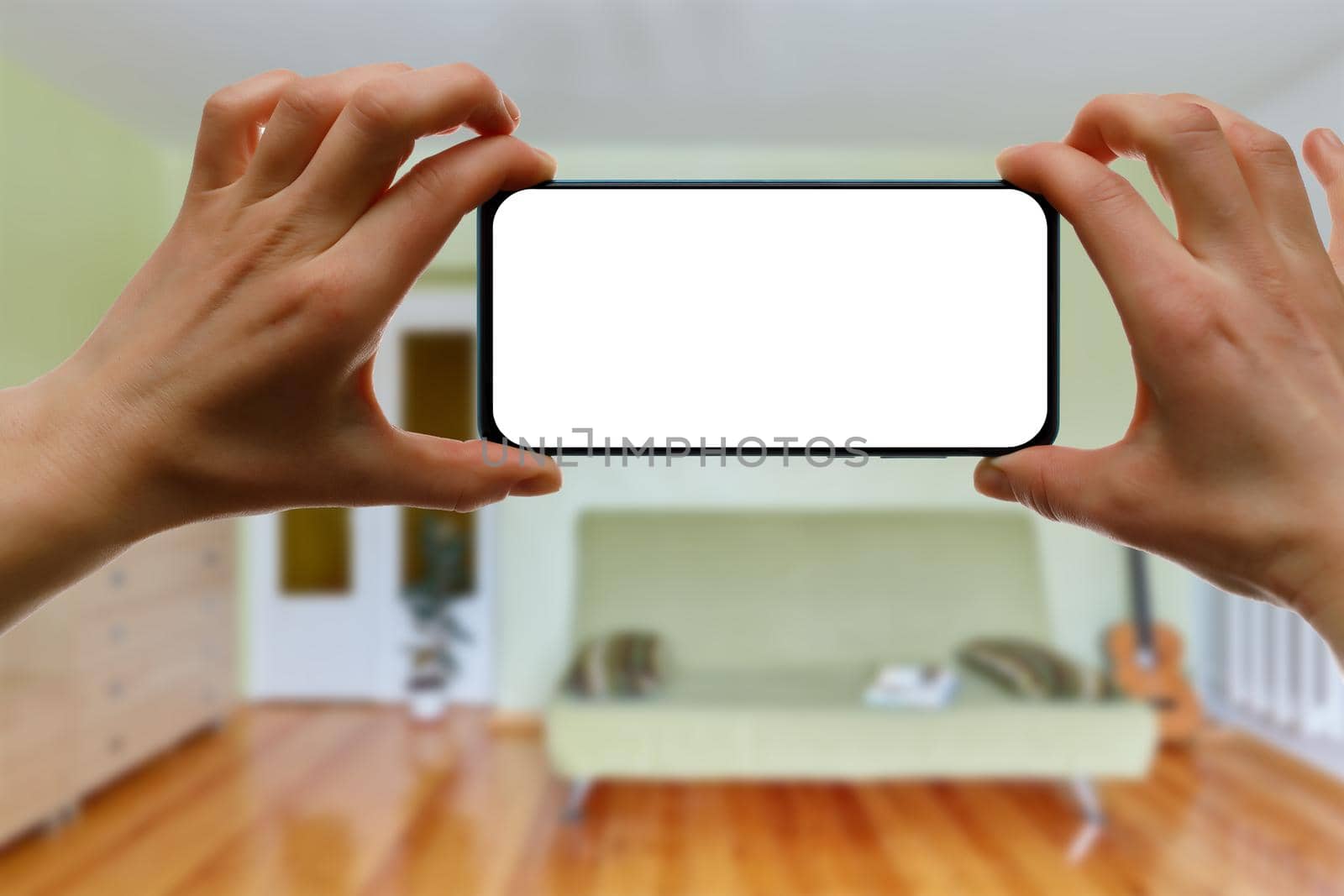 Mockup of using a smartphone in the home interior. Blank white screen for your idea