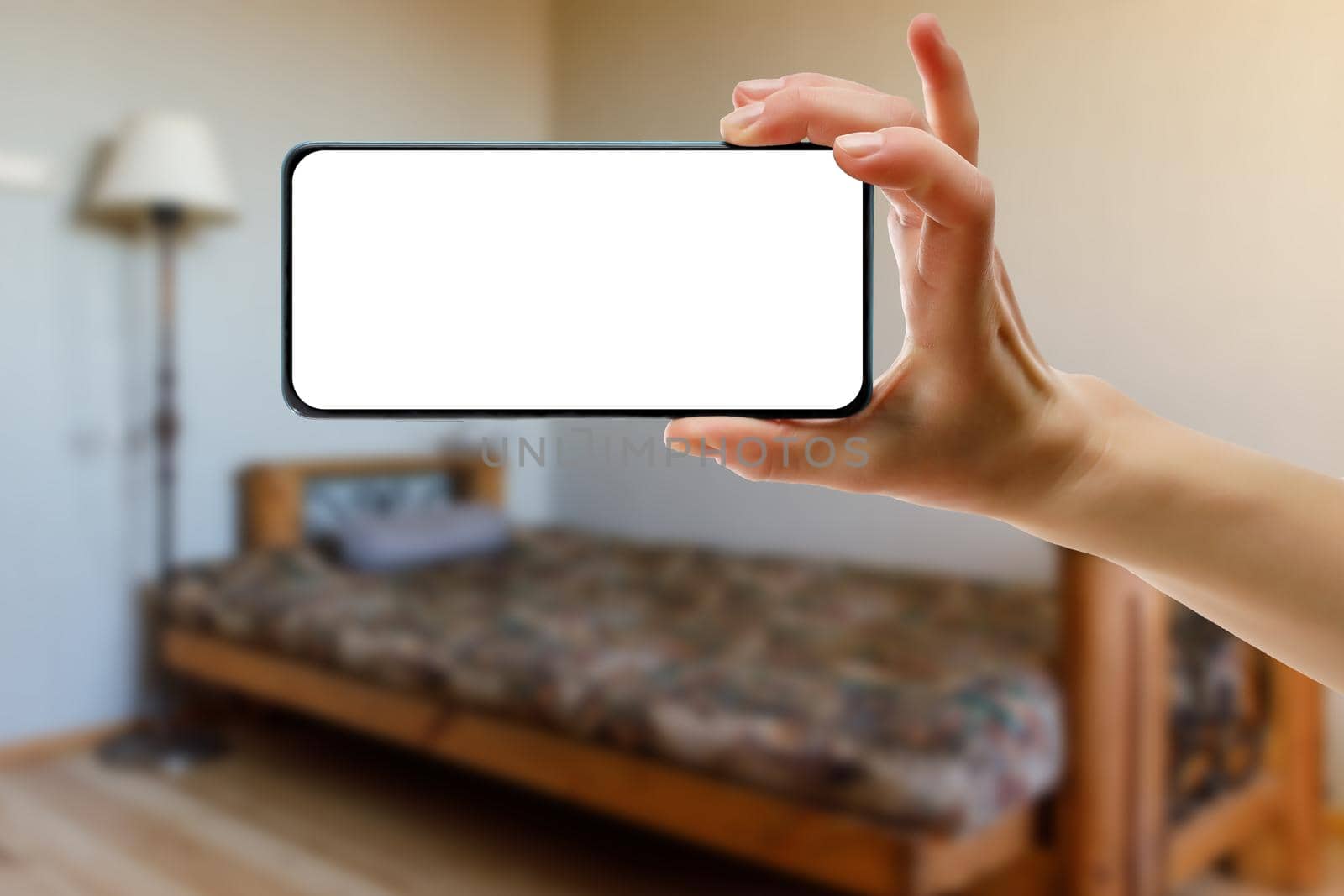 Mockup of using a smartphone in the home interior. Blank white screen for your idea. by 9parusnikov