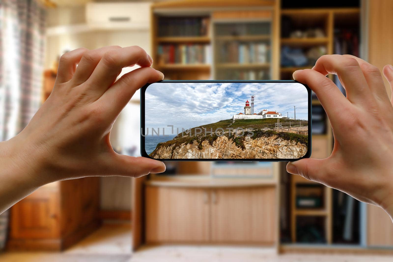 Travel at home concept. Online trip to Cabo da Roca, Portugal via smartphone. by 9parusnikov