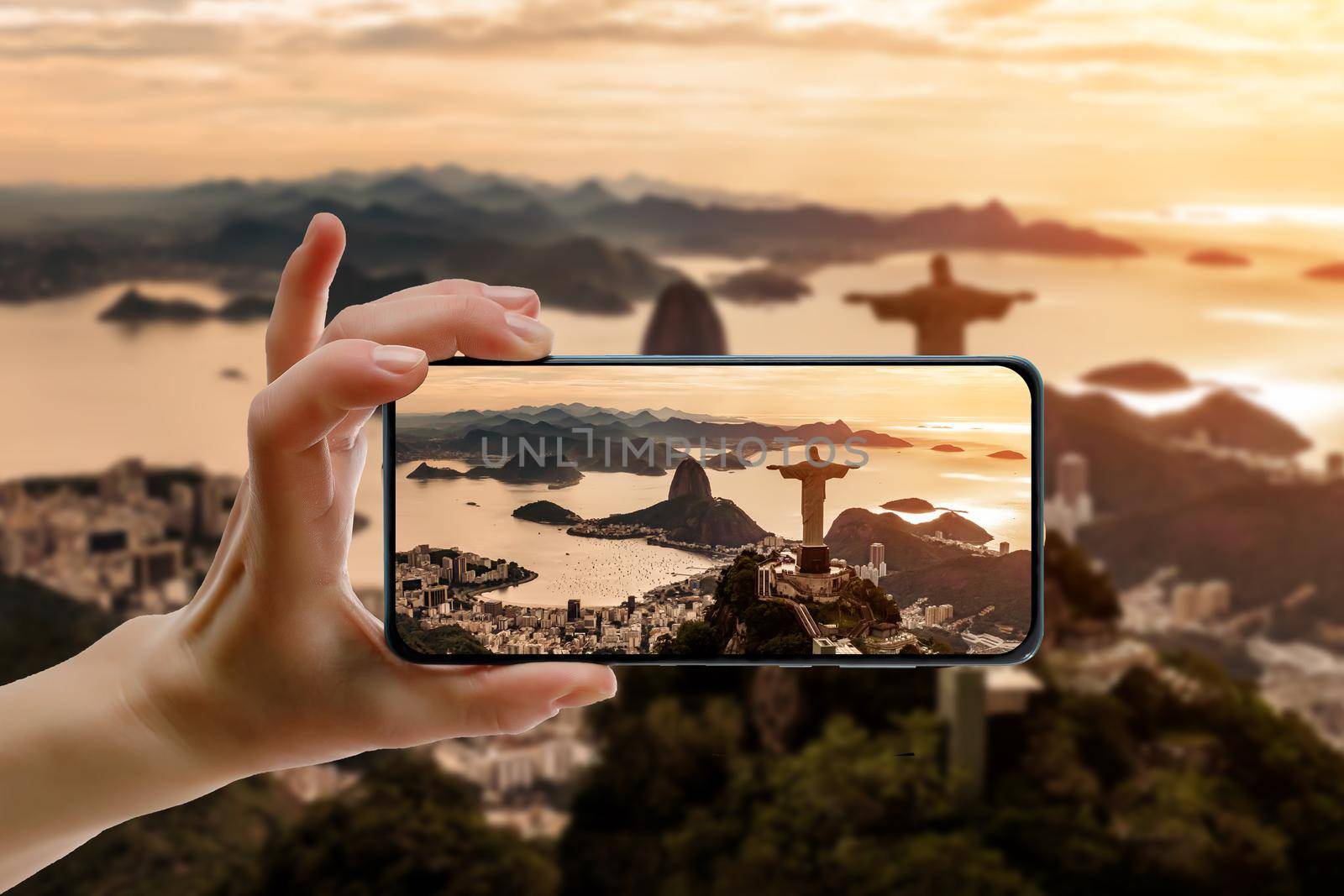 Taking a picture via a cell phone. Rio de Janeiro with Christ Redeemer on the screen by 9parusnikov