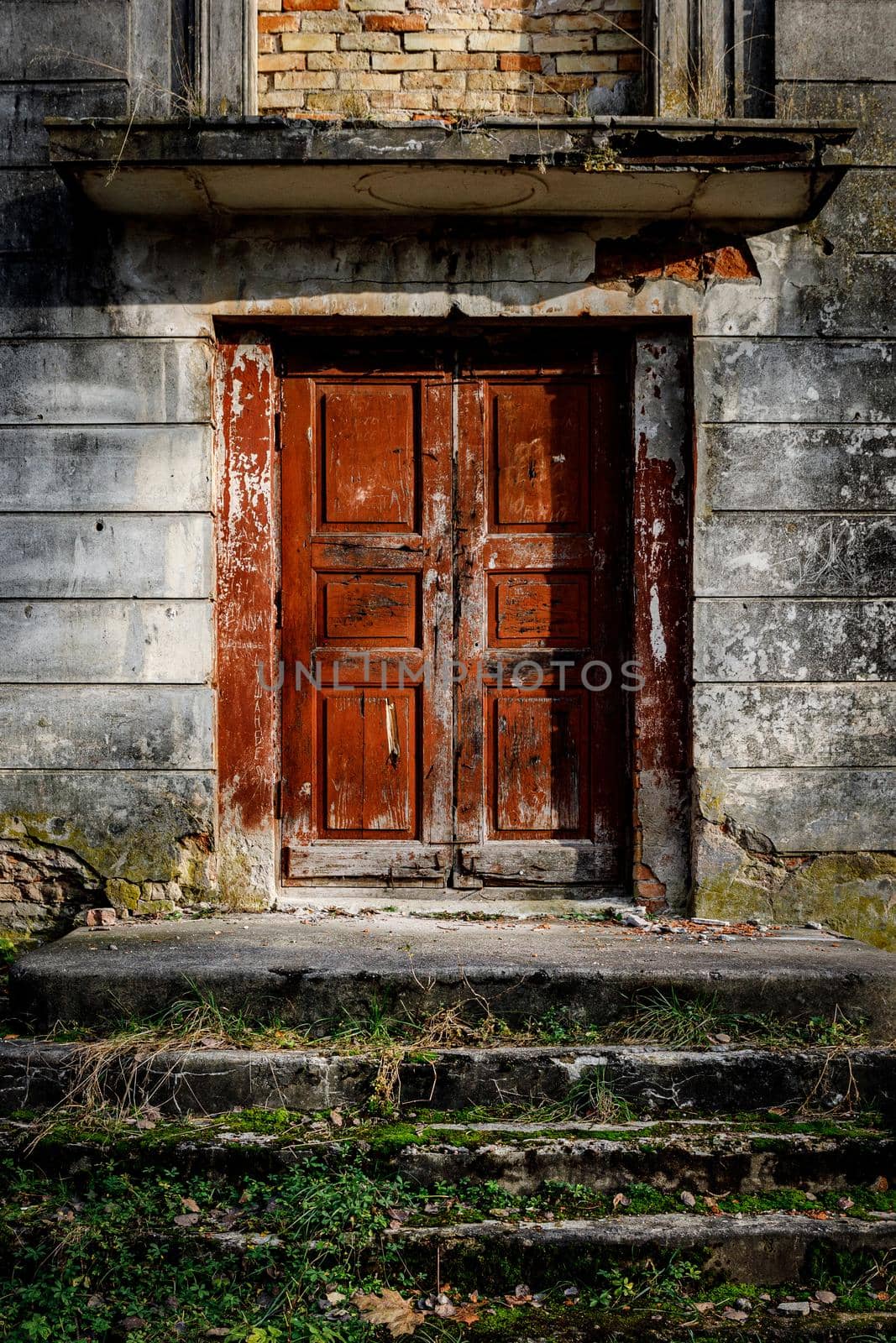 Porch of an old palace with a stone staircase and a red door. by 9parusnikov