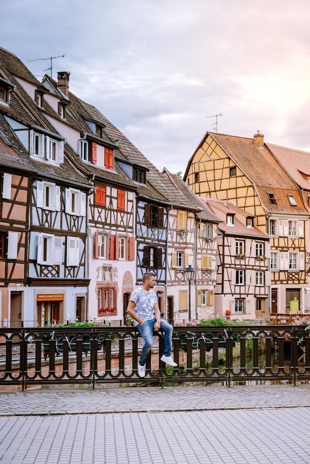 couple on city trip Colmar, Alsace, France. Petite Venice, water canal and traditional half timbered houses. Colmar is a charming town in Alsace, France. Beautiful view of colorful romantic city Colmar