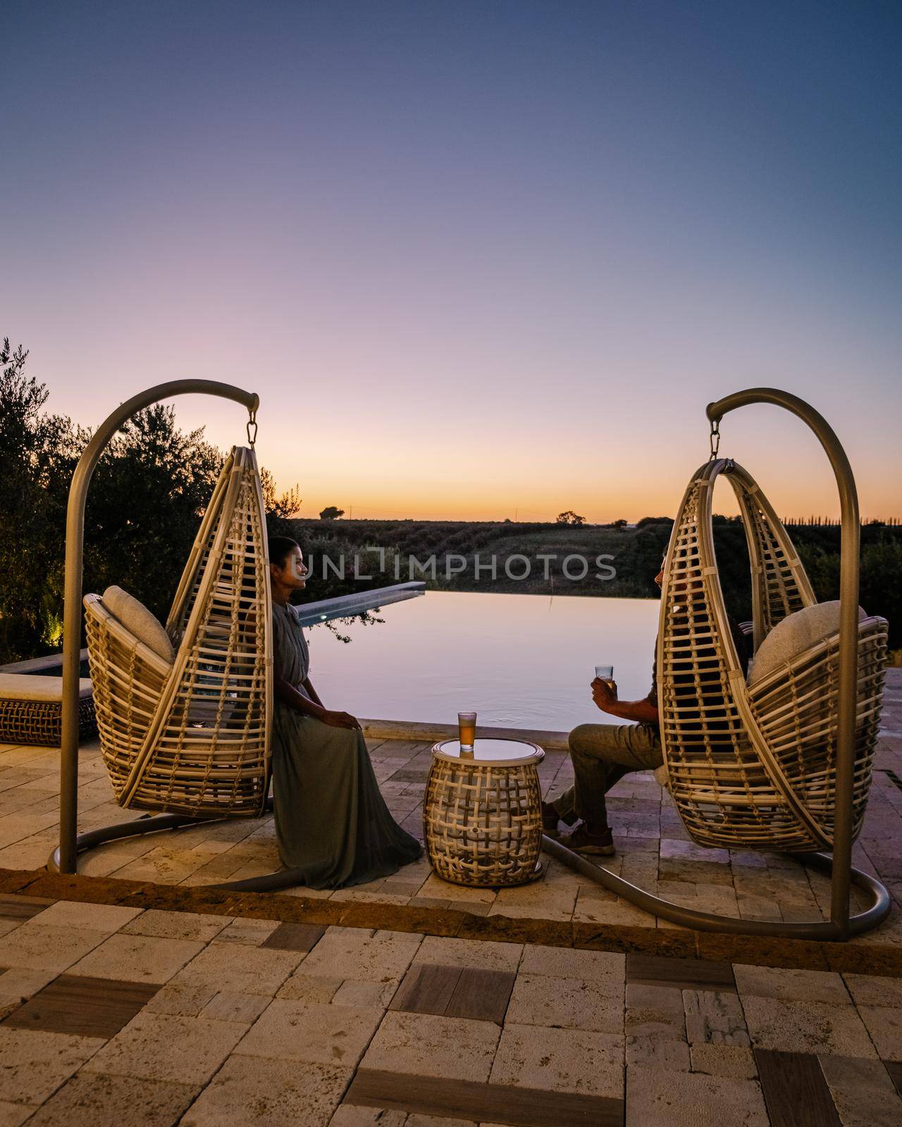 Luxury resort with a view over the wine field in Selinunte Sicily Italy. infinity pool with a view over wine fields in Sicilia, couple on vacation at luxury resort