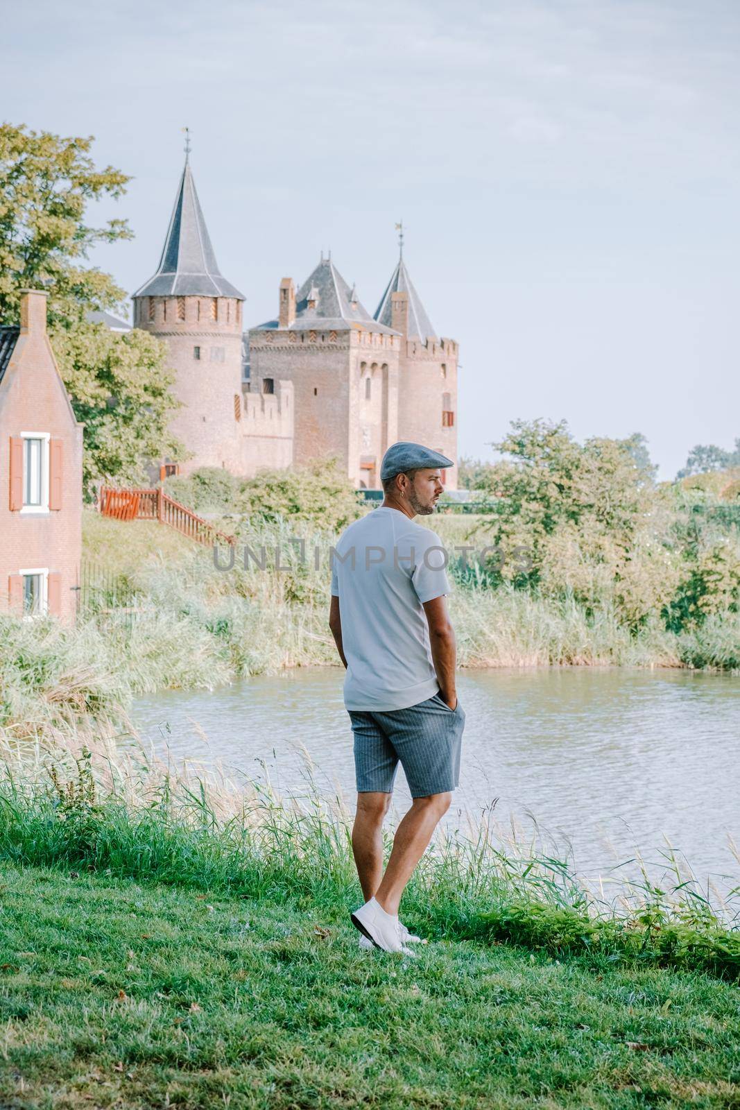 Muiderslot castle near Amsterdam - Netherlands, Muideslot during summer in the Netherlands. Europe young men visit castle