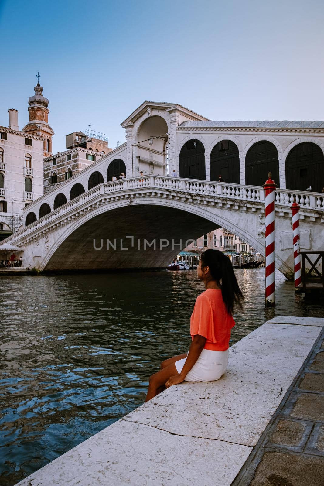 woman on a city trip to Venice Italy, colorful streets with canals Venice. Europe
