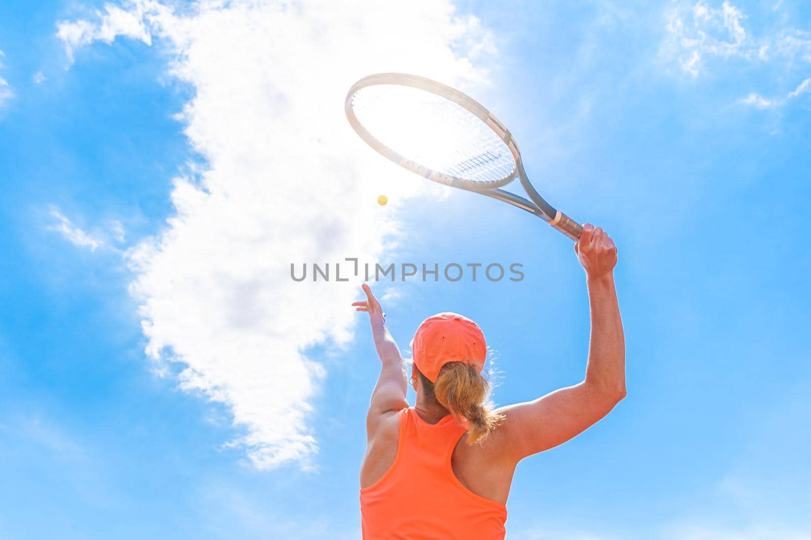 tennis serve by a young woman on the court.