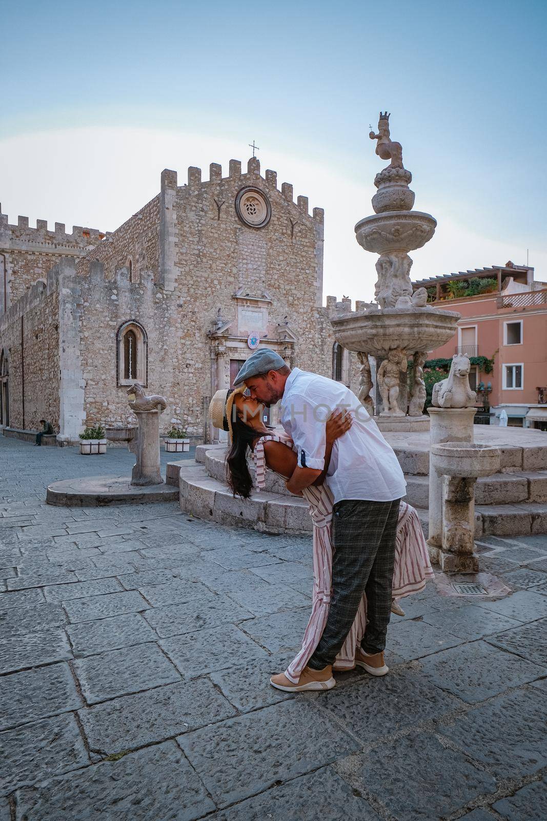 Taormina Sicily, Belvedere of Taormina and San Giuseppe church on the square Piazza IX Aprile in Taormina. Sicily, Italy. Couple on vacation at the Italian Island Sicily