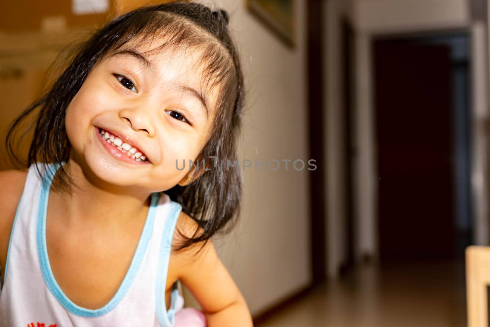 Pretty little girl close up shot while smiling and shoeing her cute teeth