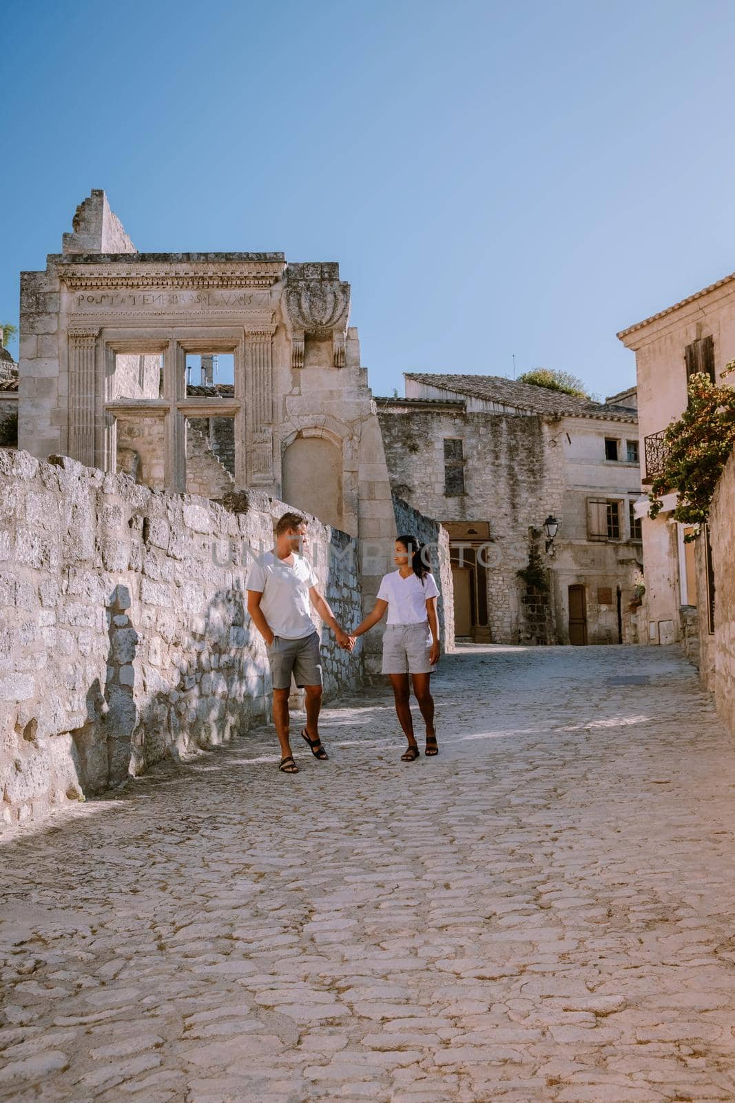 couple visit the town of Les Baux de Provence France, old historical village build on a hill in the Provence, Les Baux de Provence village on the rock formation and its castle. France, Europe by fokkebok