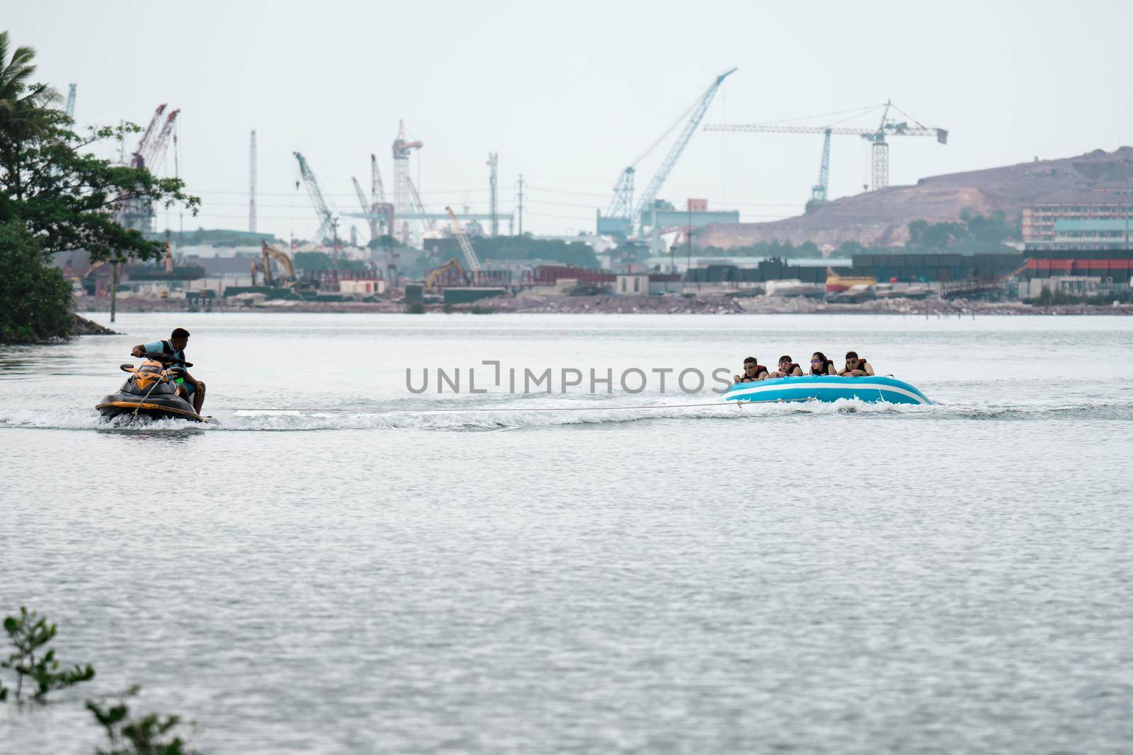 Beach water sports tubing with tourist being pulled by jetski in a beach in batam indonesia, Indonesia, May 4 2019