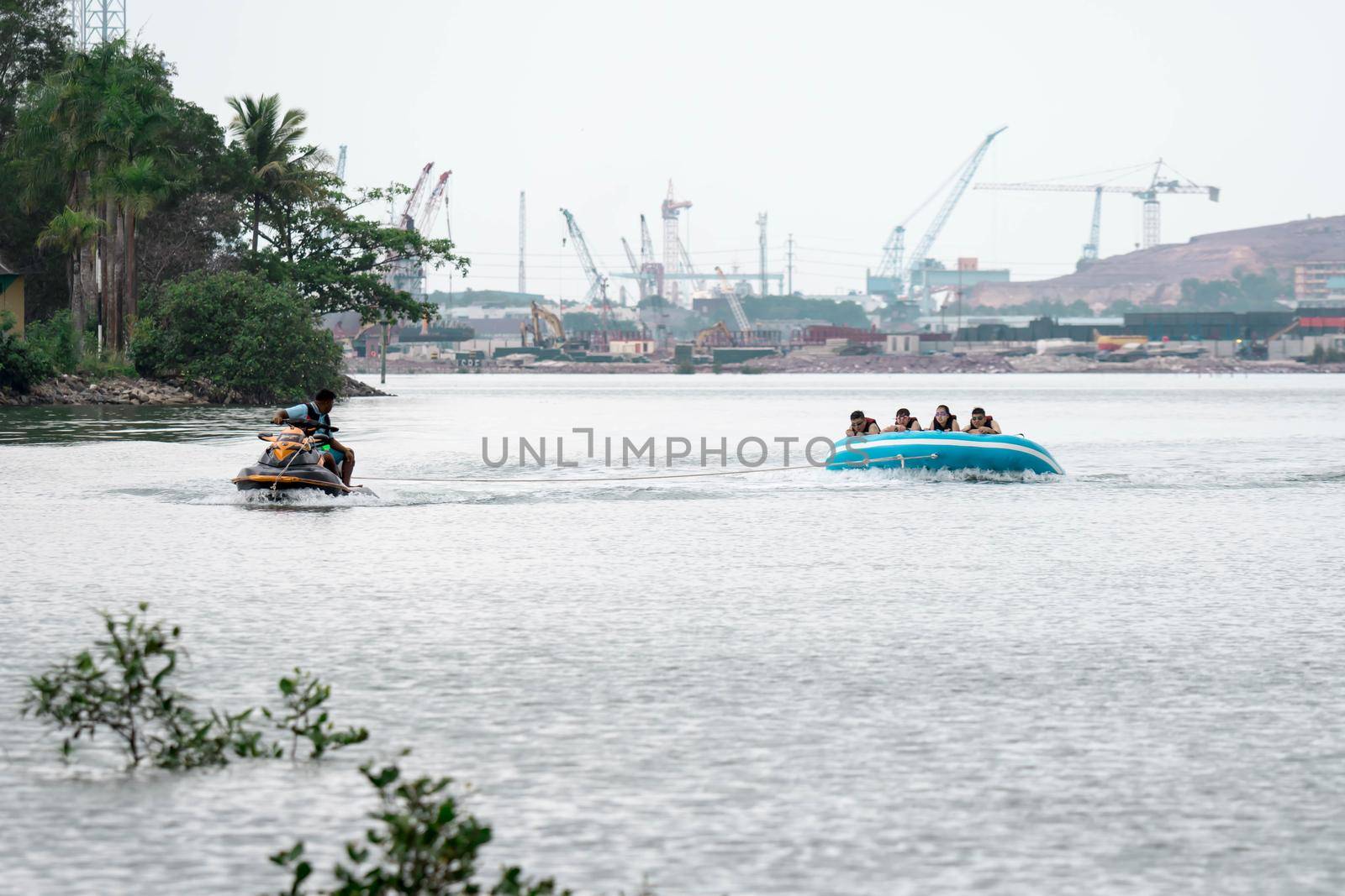 Beach water sports tubing with tourist being pulled by jetski in a beach in batam indonesia, Indonesia, May 4 2019