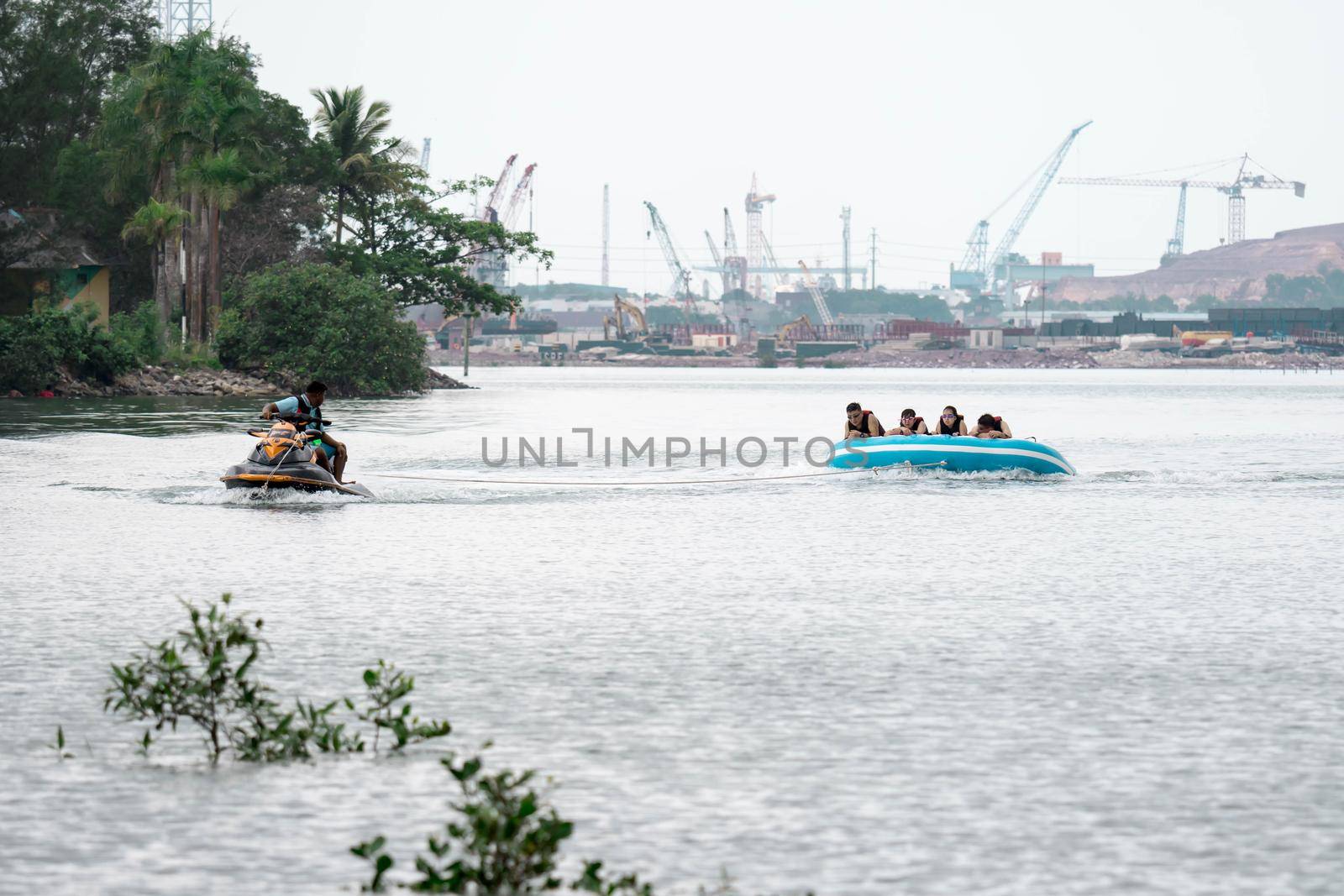 Beach water sports tubing with tourist being pulled by jetski in a beach in batam indonesia, Indonesia, May 4 2019