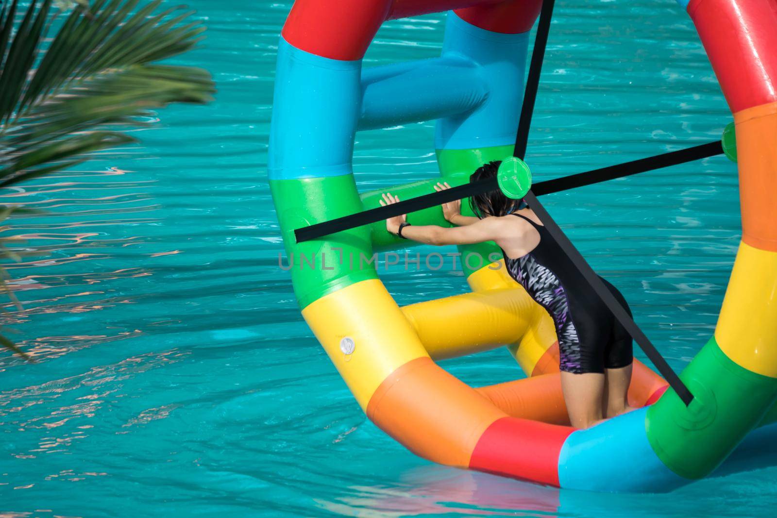 Swimming pool water sports large wheel tubing. Colorful water wheel tubing in a swimming pools