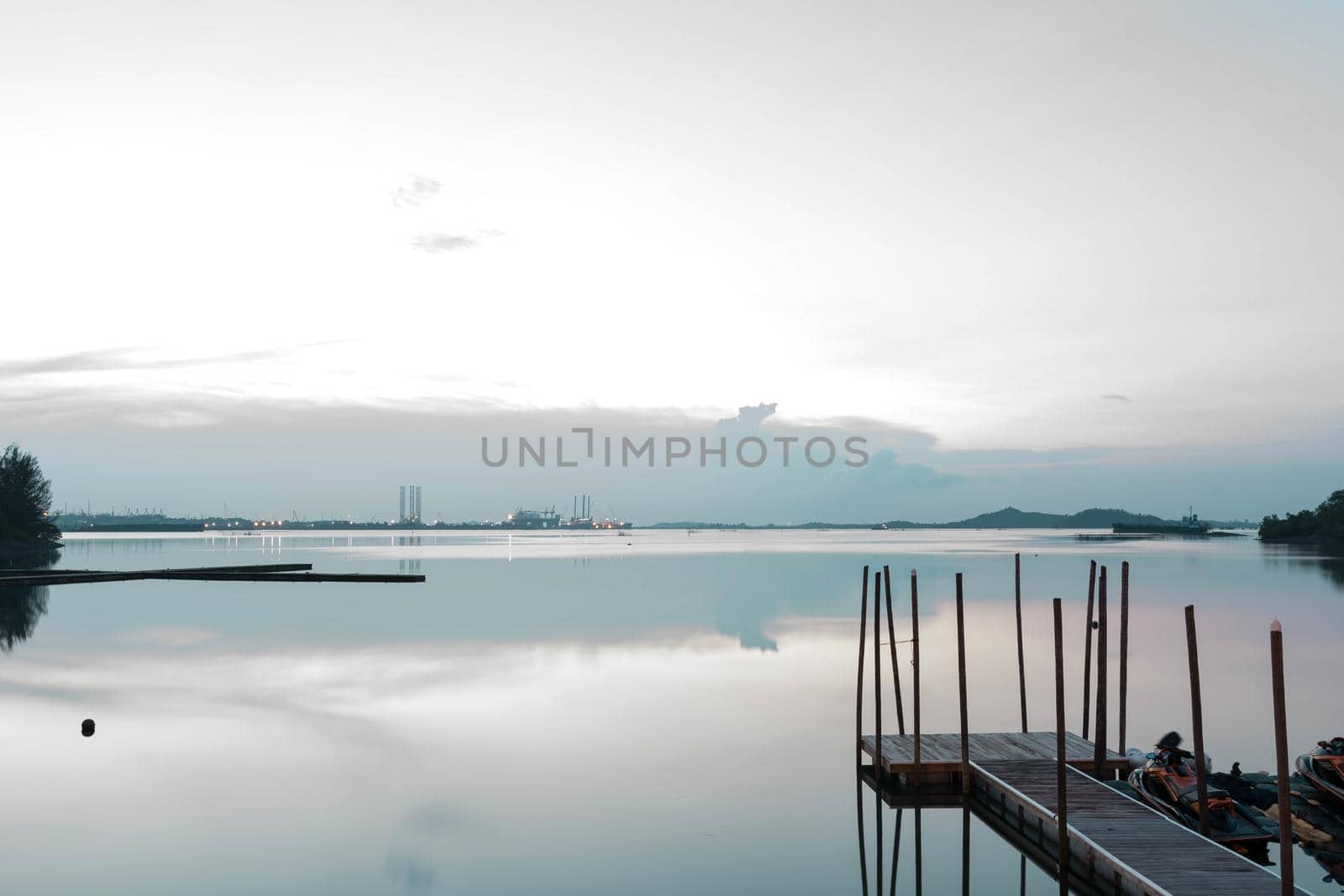 Beach landscape view with wooden foot bridge during sunset. Beatiful screnery of a beach with ocean and sky and water reflections