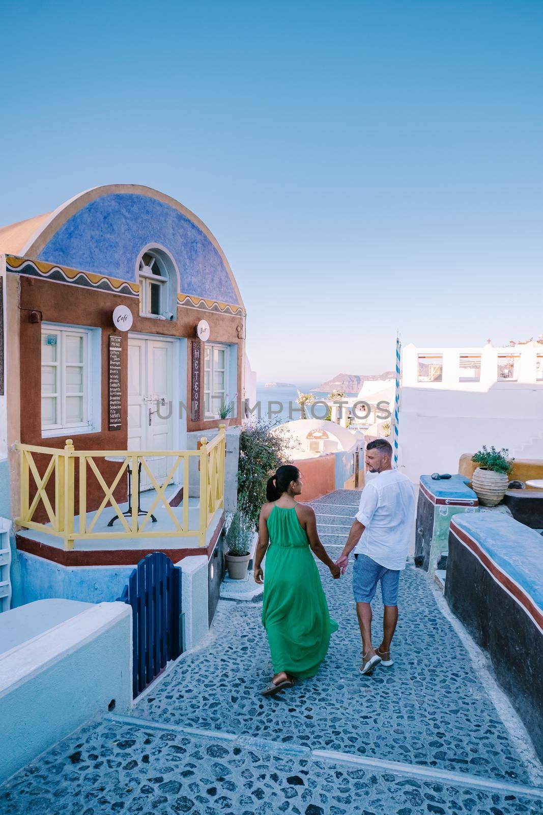 Santorini Greece August 2020, streets of Oia on a early morning with cafe and restaurant by fokkebok