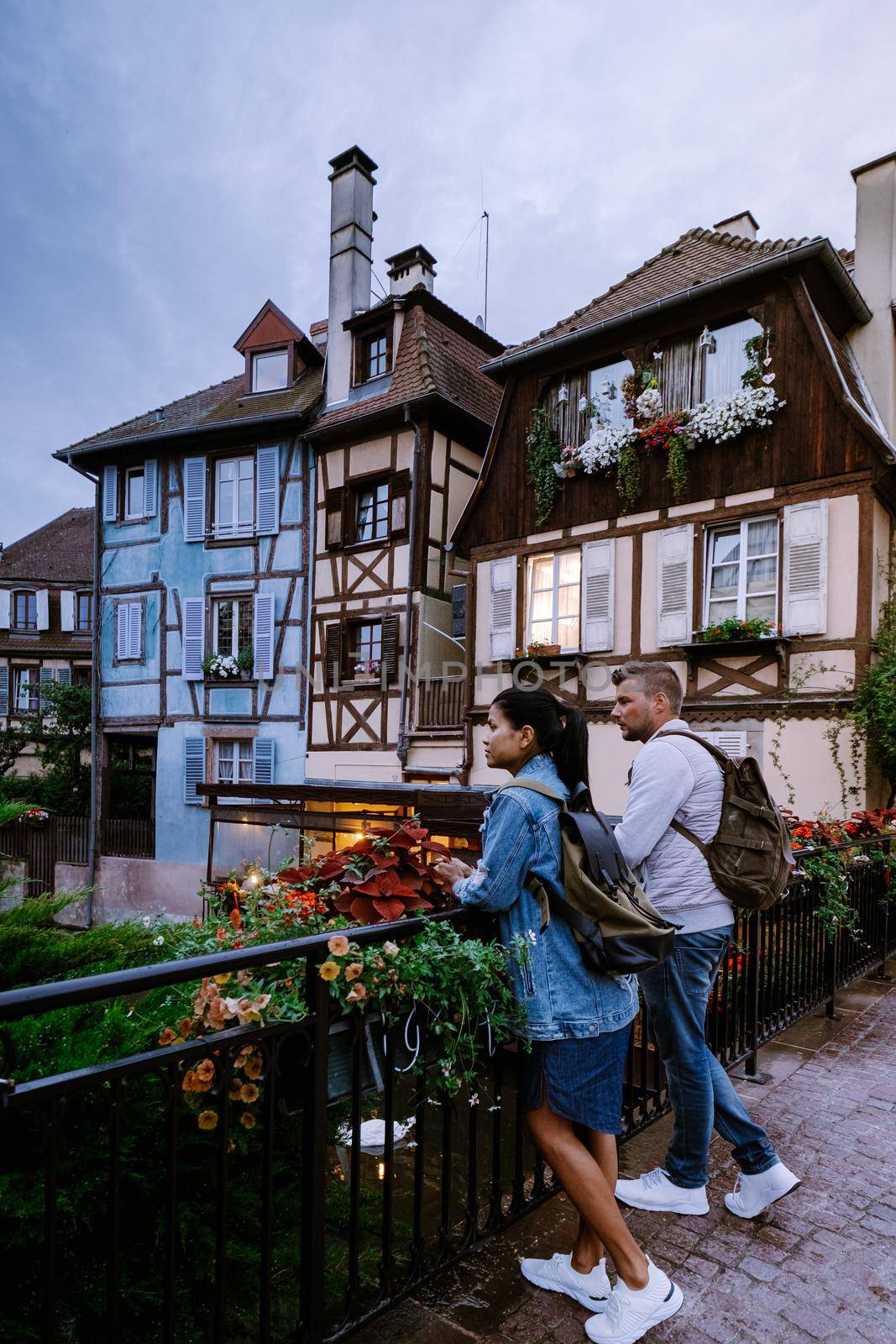 couple on city trip Colmar, Alsace, France. Petite Venice, water canal and traditional half timbered houses. Colmar is a charming town in Alsace, France. Beautiful view of colorful romantic city Colmar, France, Alsace by fokkebok