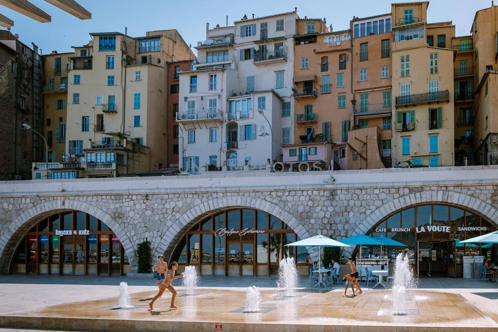 Menton France,Cote d Azur June 2020, warm hot summer day at waterfront beach and a view on old part of Menton, Provence-Alpes-Cote d'Azur, France by fokkebok