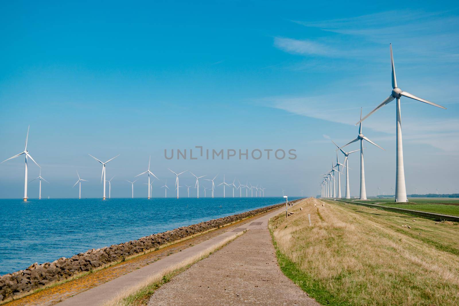 offshore windmill park with stormy clouds and a blue sky, windmill park in the ocean by fokkebok