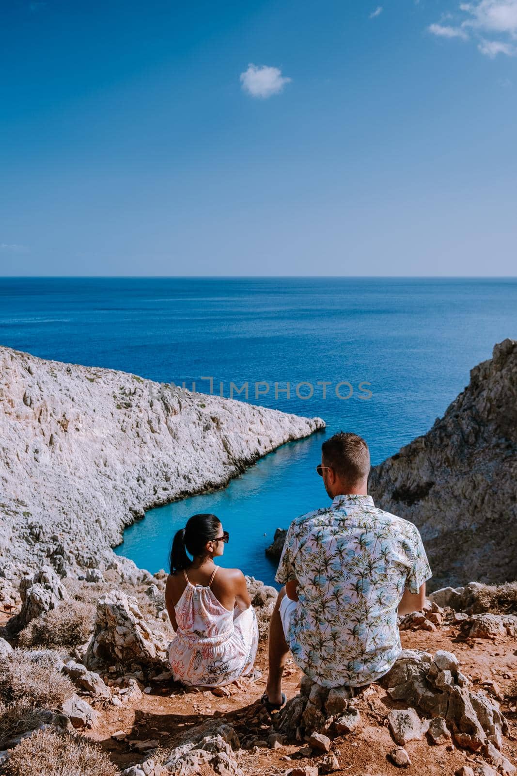 Crete Greece Seitan Limania beach with huge cliff by the blue ocean of the Island of Crete in Greece, Seitan limania beach on Crete, Greece. Europe, young couple mid age on vacation Crete 