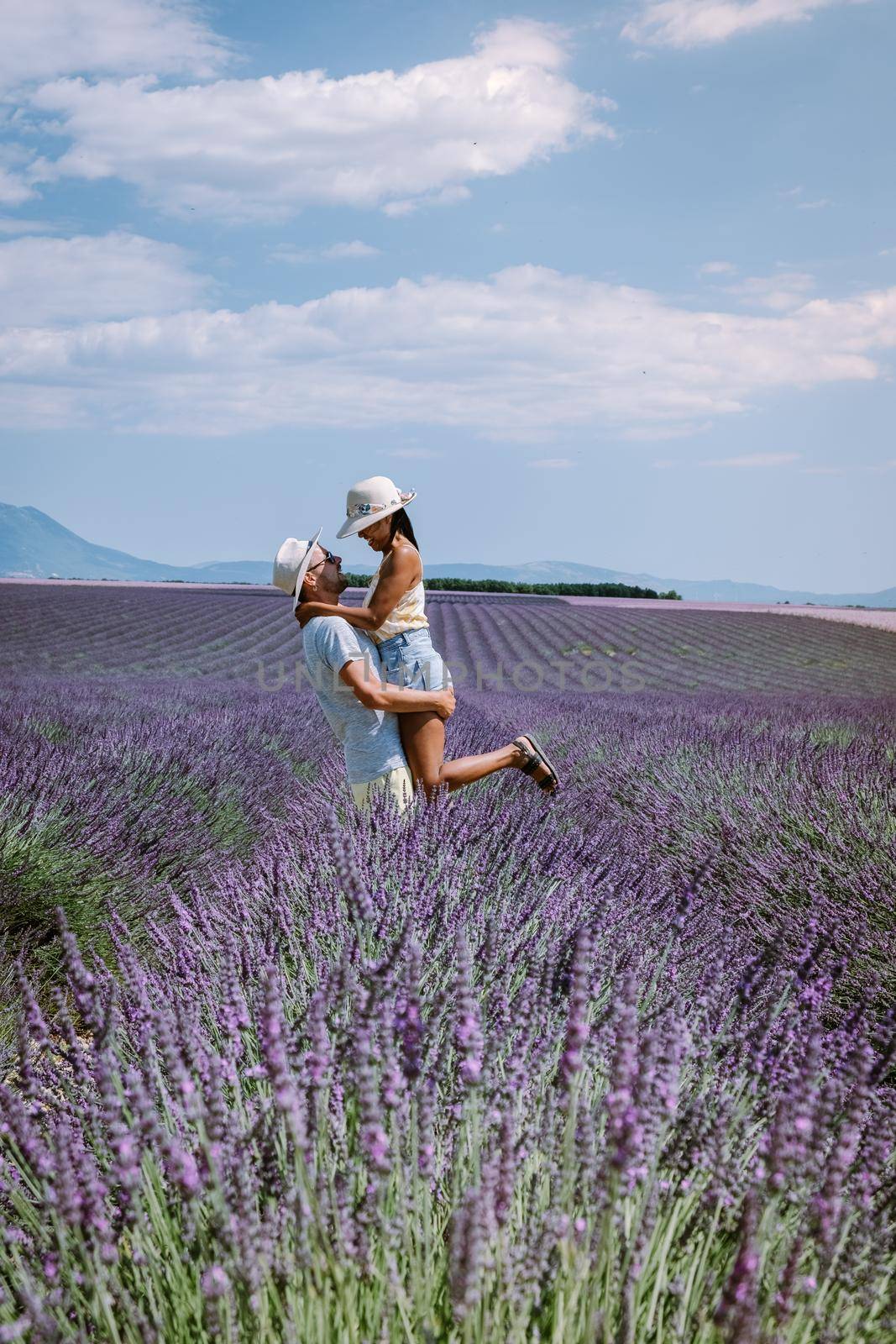 Couple men and woman on vacation at the provence lavender fields, Provence, Lavender field France, Valensole Plateau, colorful field of Lavender Valensole Plateau, Provence, Southern France. Lavender field by fokkebok