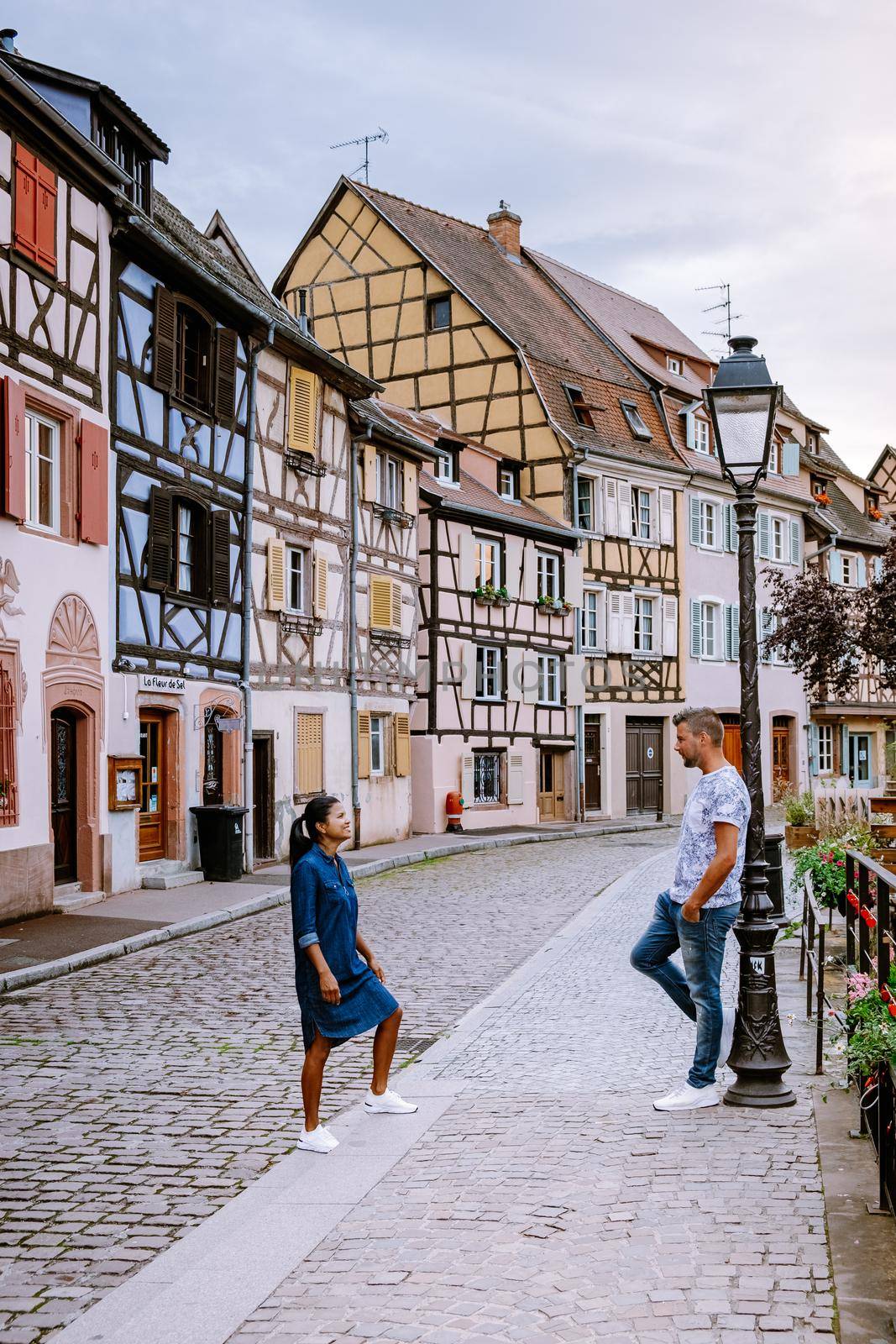 couple on city trip Colmar, Alsace, France. Petite Venice, water canal and traditional half timbered houses. Colmar is a charming town in Alsace, France. Beautiful view of colorful romantic city Colmar, France, Alsace by fokkebok