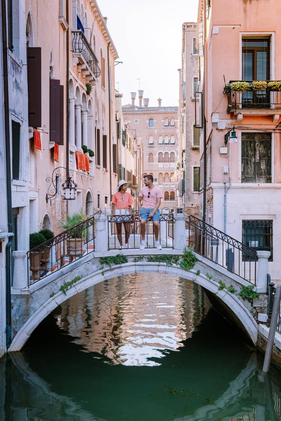 couple men and woman on a city trip to Venice Italy, colorful streets with canals Venice by fokkebok
