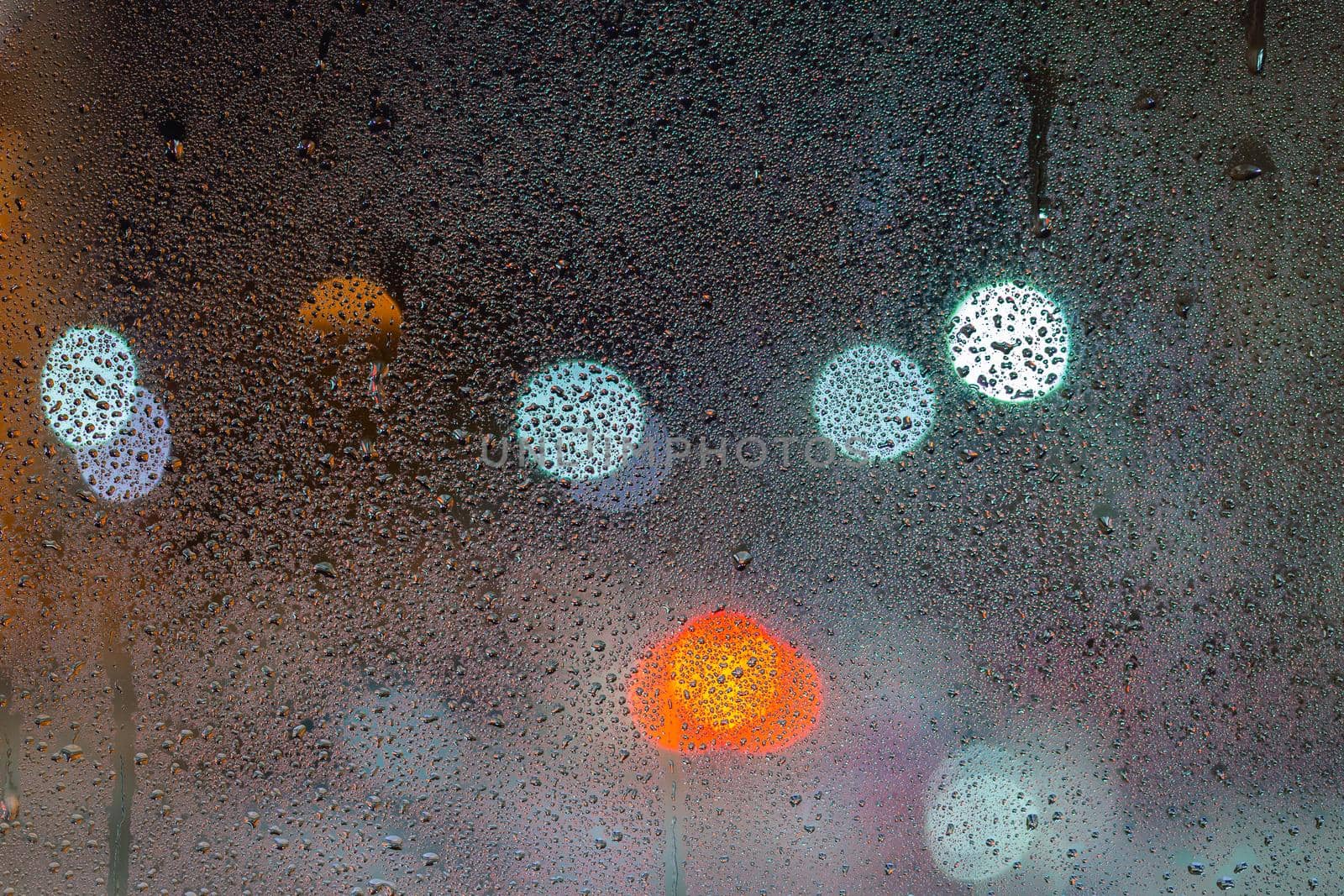 an abstract background of night wet window glass.