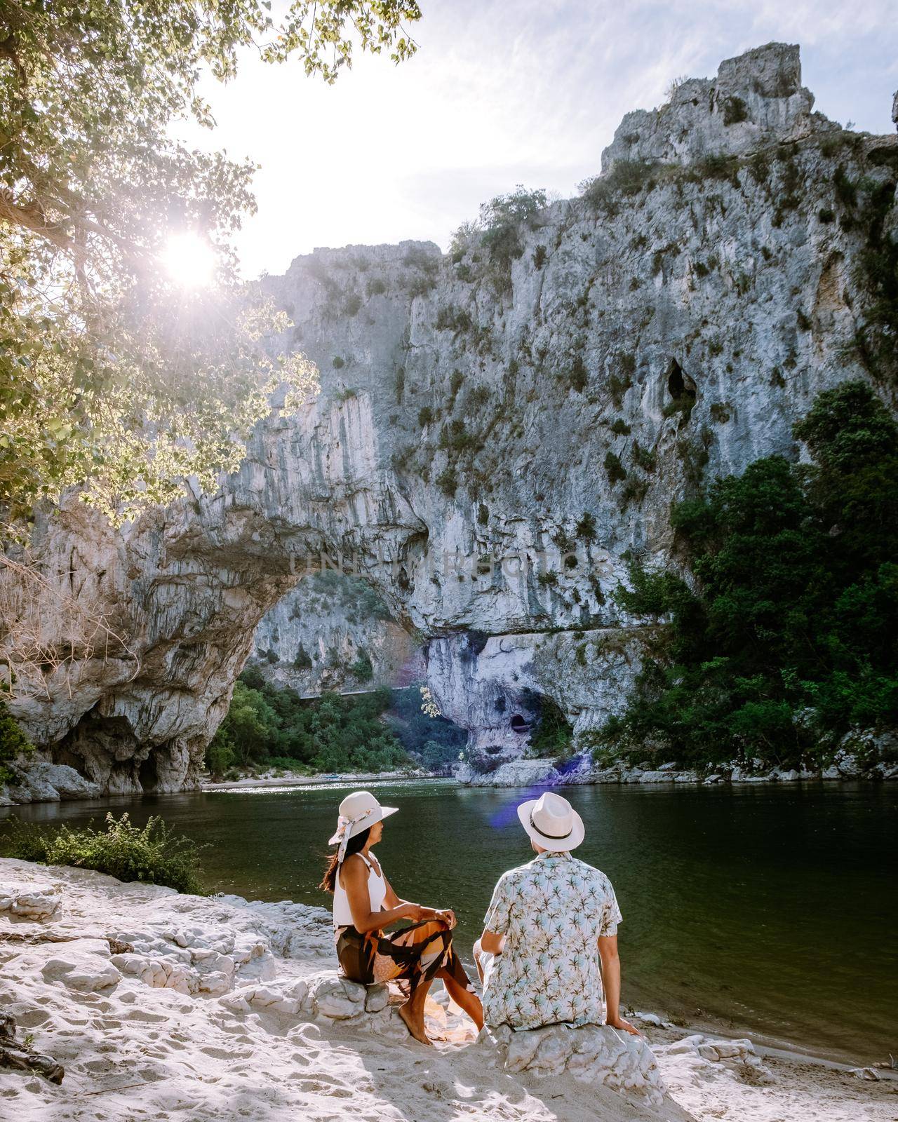 couple on the beach by the river in the Ardeche France Pont d Arc, Ardeche France,view of Narural arch in Vallon Pont D'arc in Ardeche canyon in France Europe